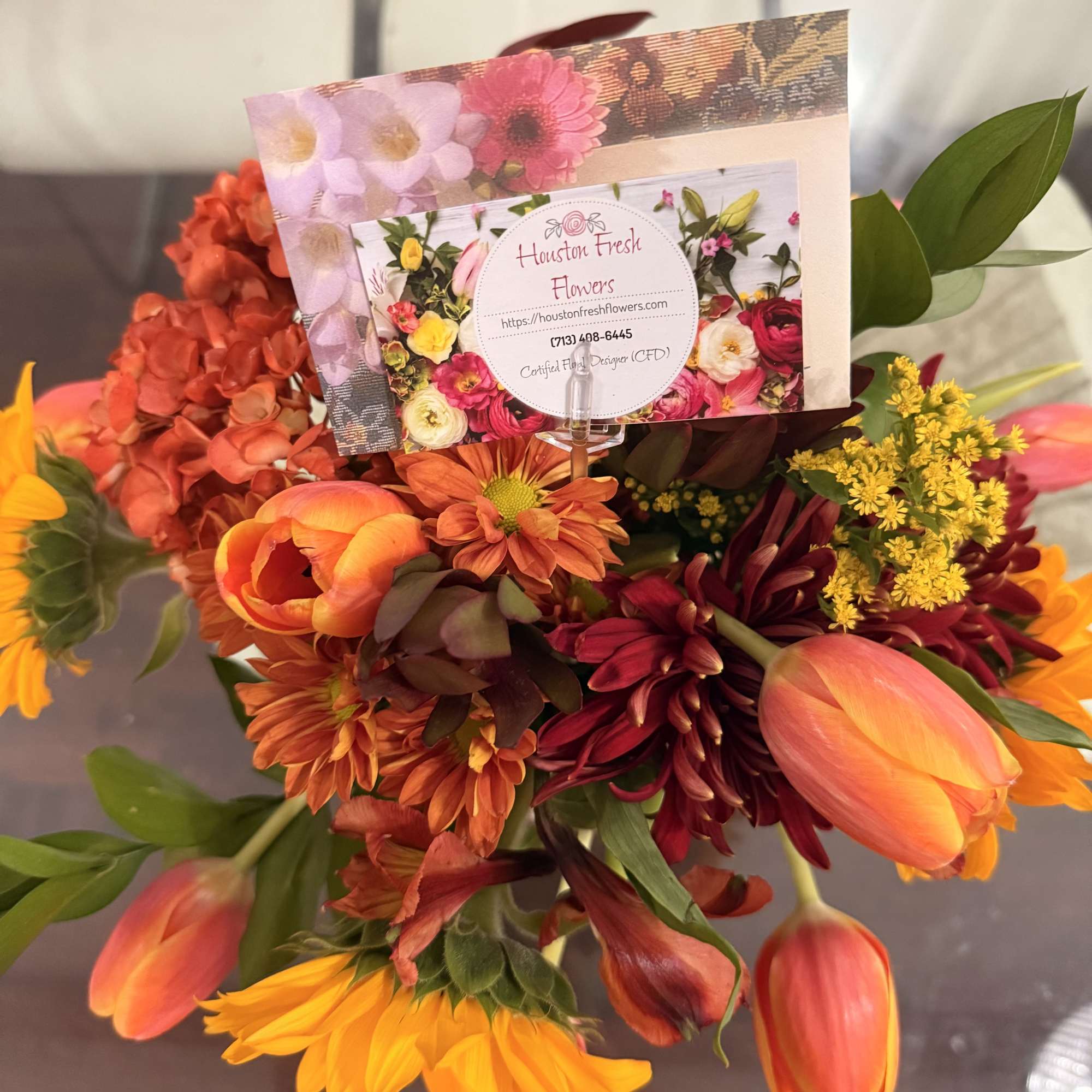 This is a vibrant fall-inspired arrangement that radiates warmth and coziness. The