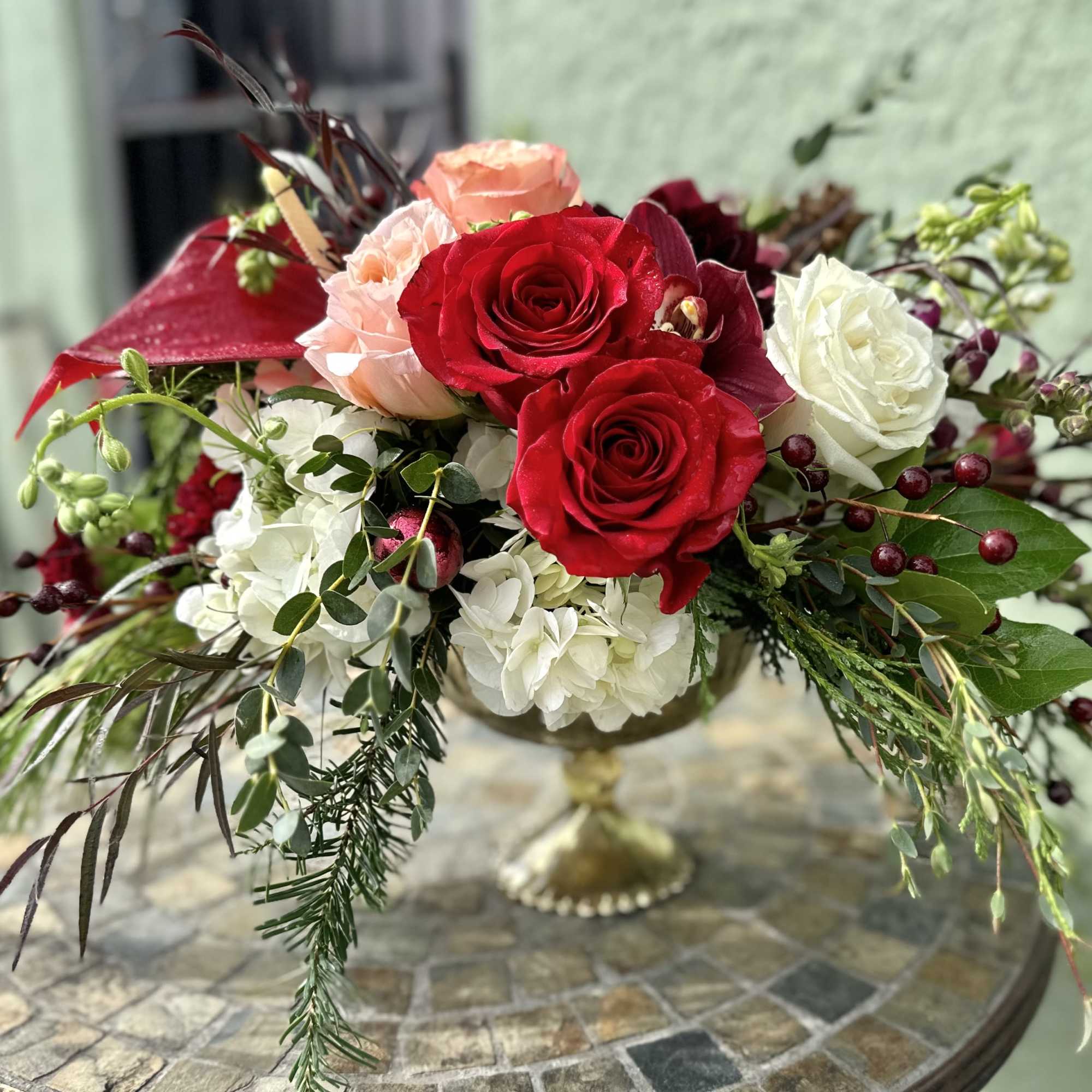 Gorgeous and elegant red, burgundy, peach color centerpiece set on footed mercury