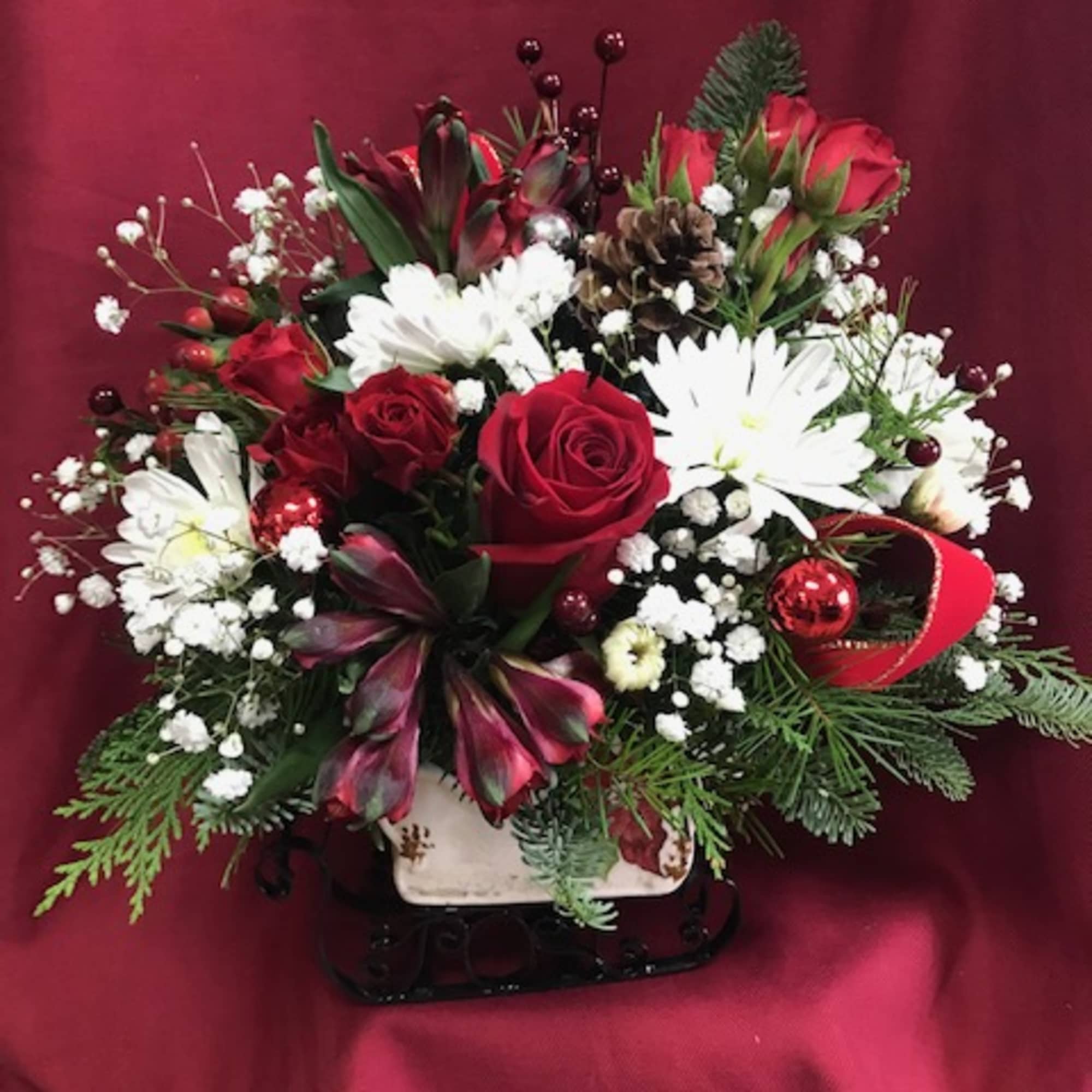 Our collectable sleigh, filled with evergreens and
flowers for the season.