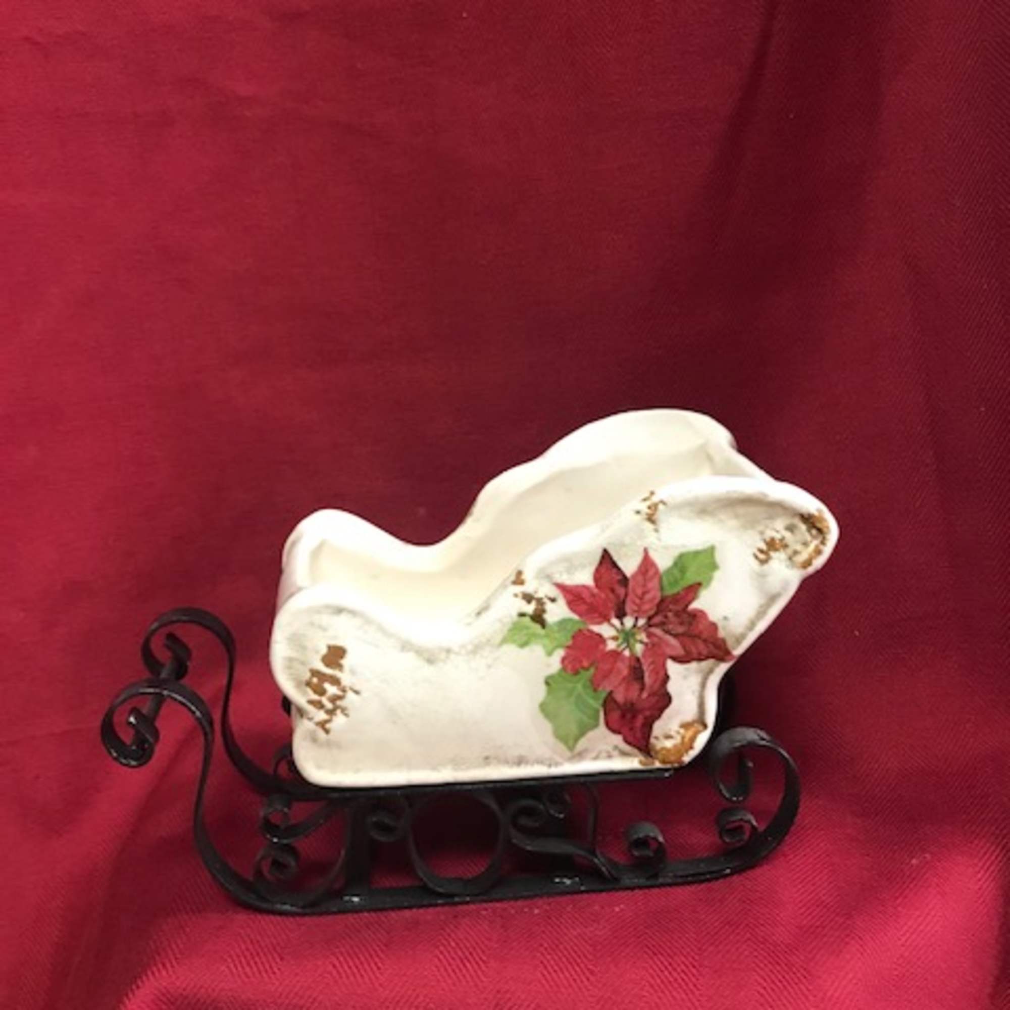 Our collectable sleigh, filled with evergreens and
flowers for the season.