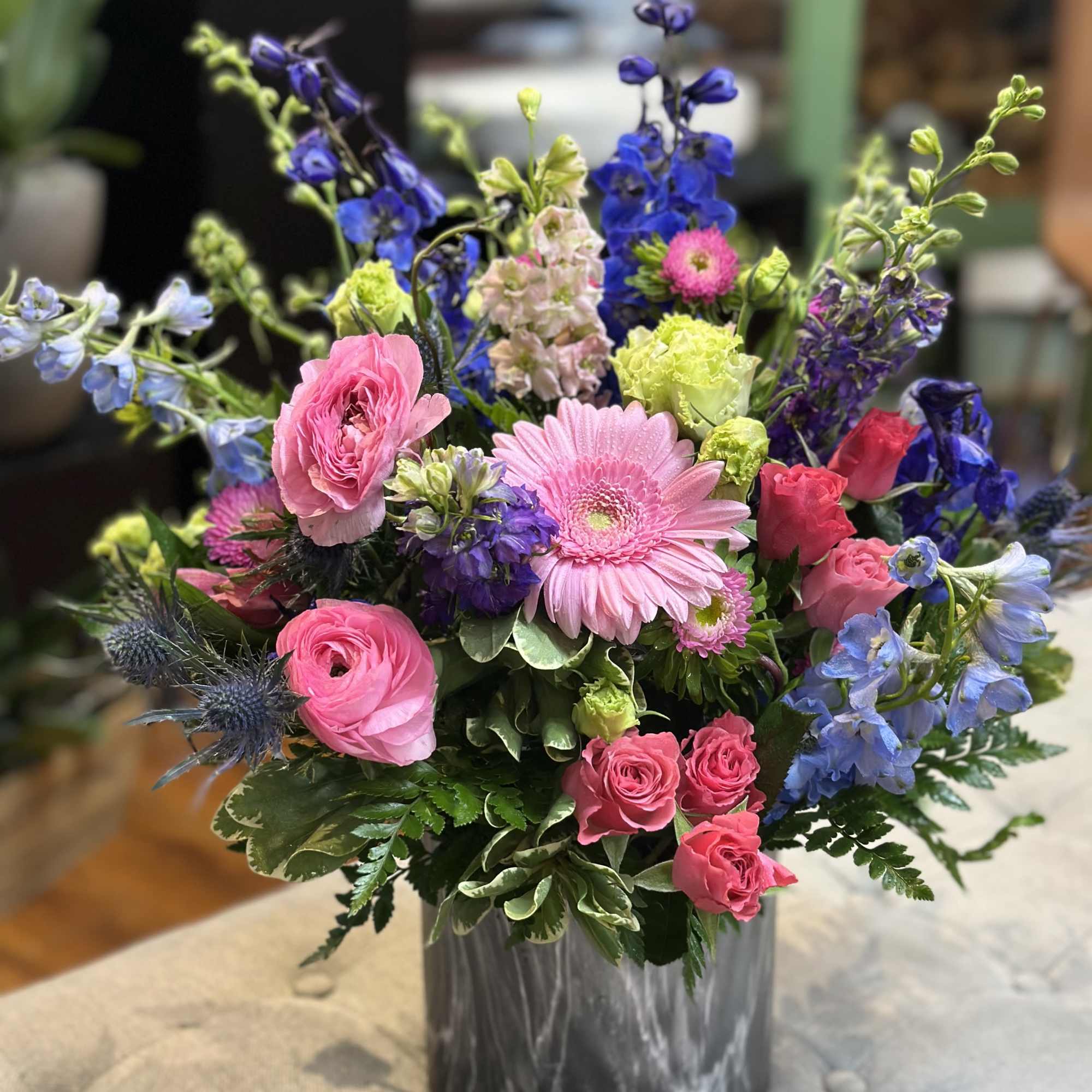 Midnight Garden is a striking floral arrangement where bold meets beautiful. With