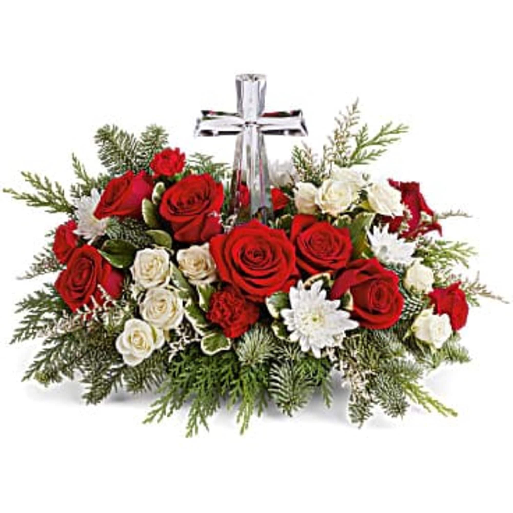 The crystal cross is nestled elegantly among red and white blooms, this