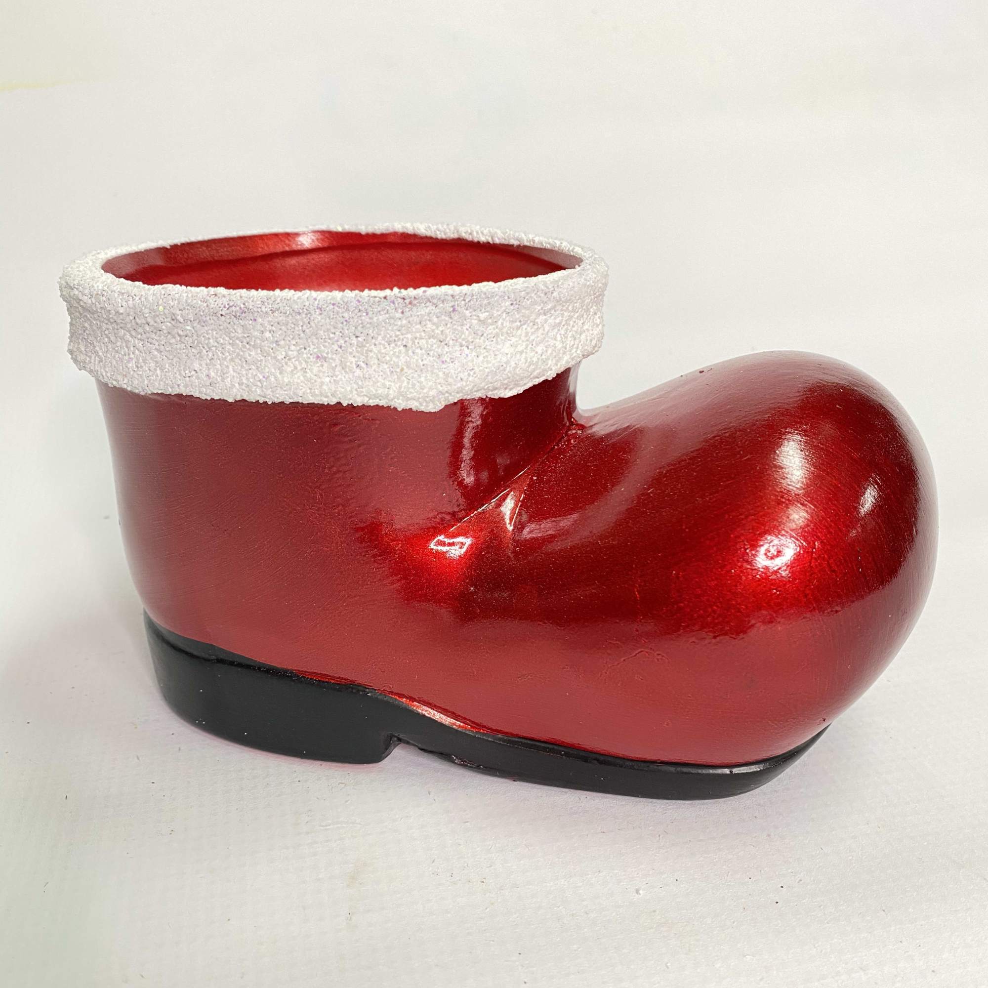 This adorable dog made out of white carnations wearing a red Santa