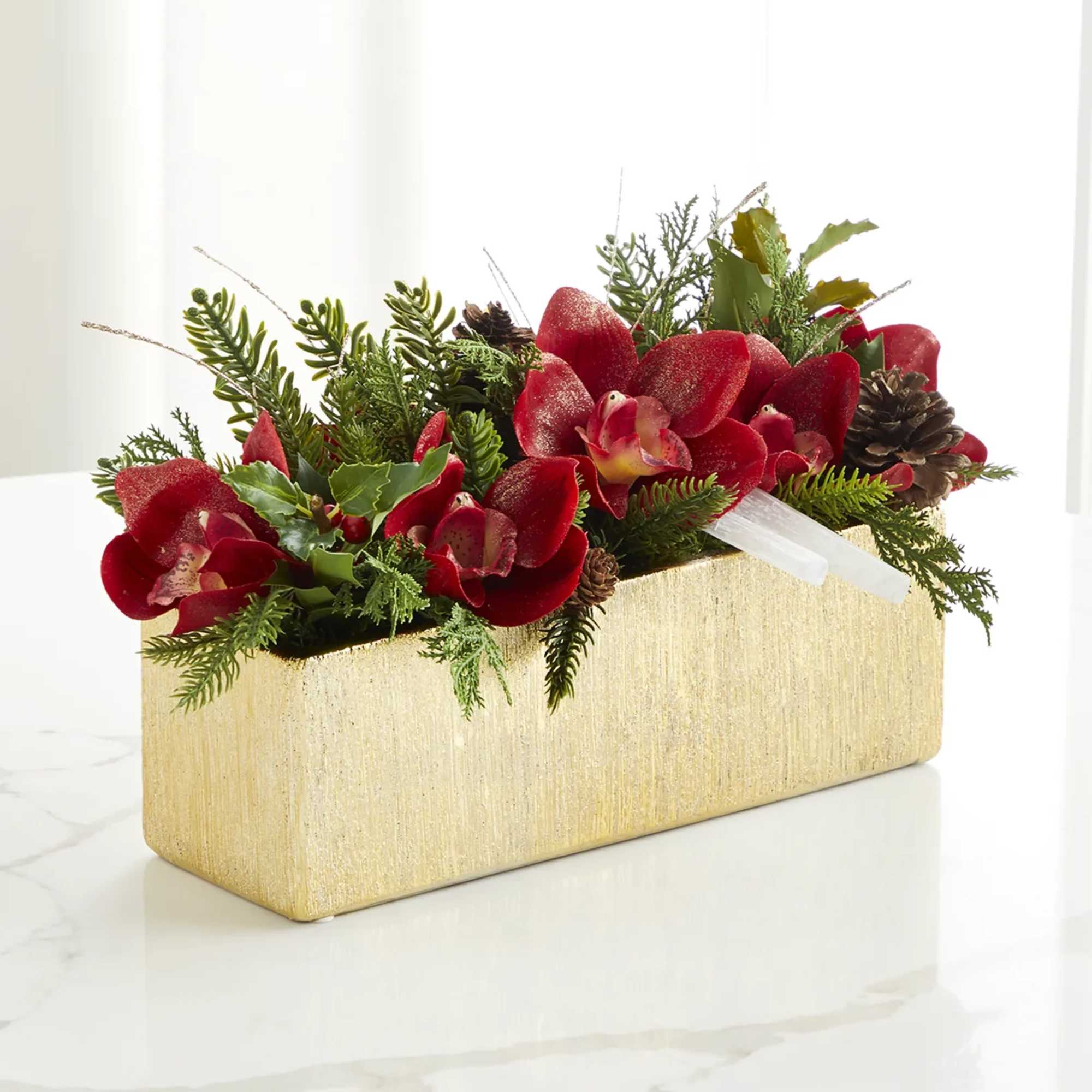 In a gold vase combination of Xmas greenery and white , red