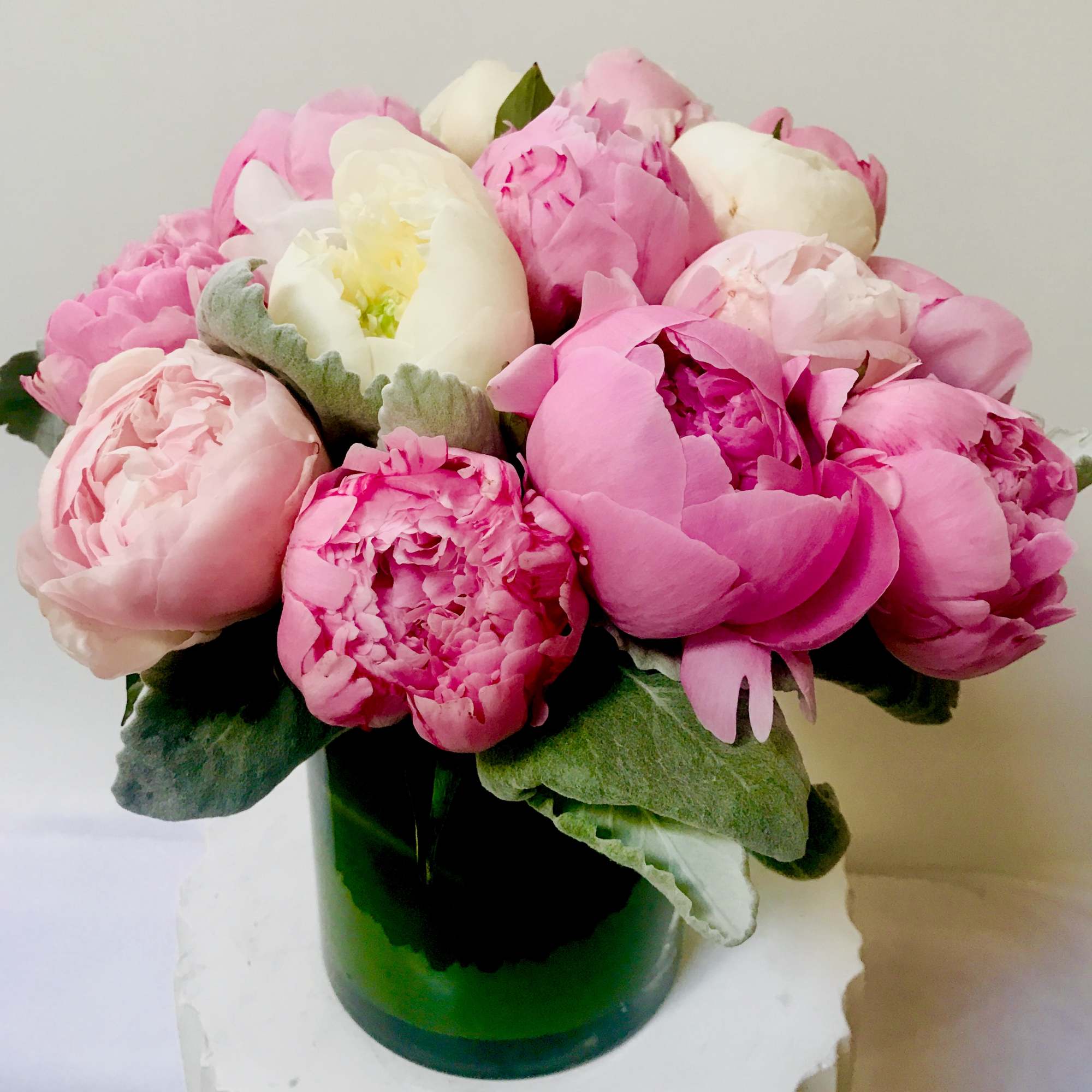 
In a  glass a 10 beautiful pink ,white peonies 
