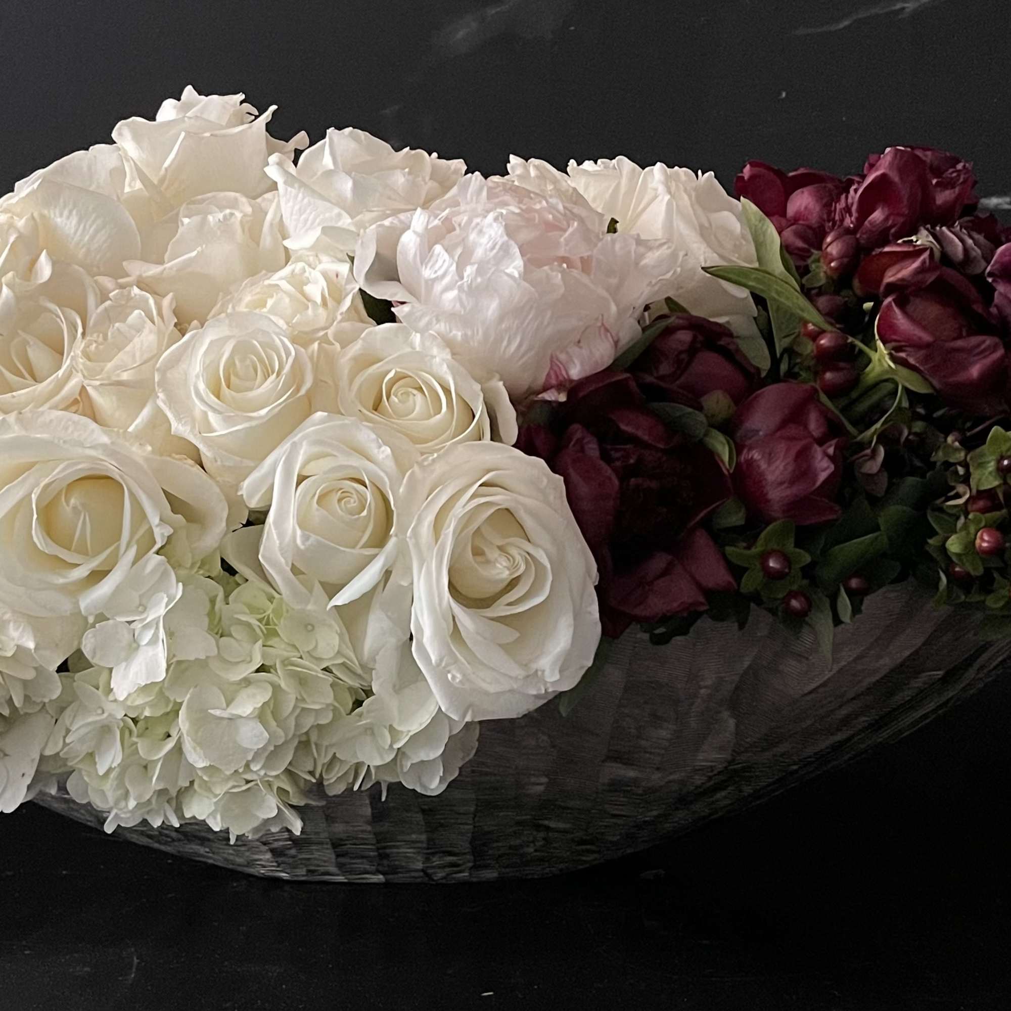 This design includes:
40 dark purple almost black callas
75 white roses
10 burgundy peonies