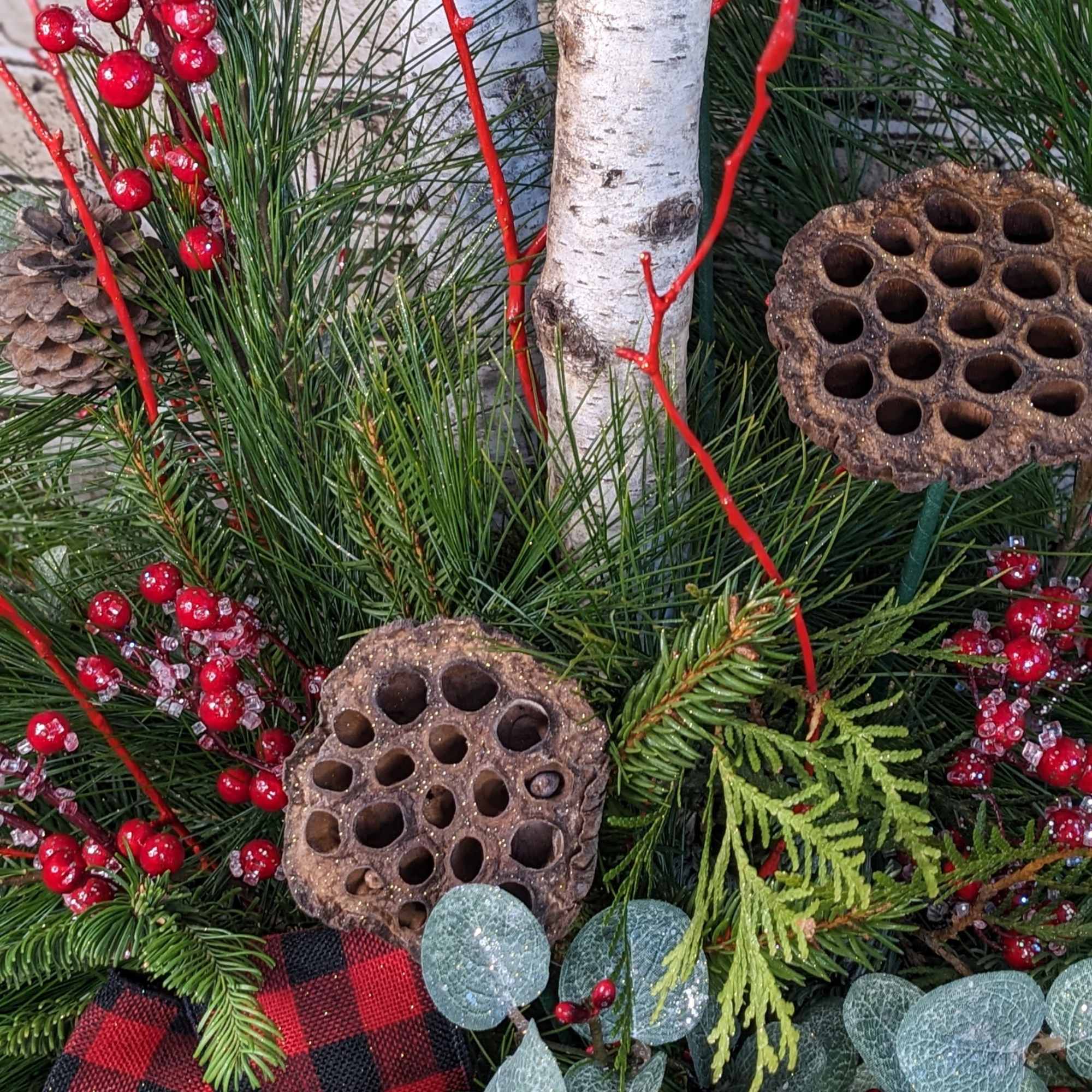A charming evergreen porch pot with a cozy country-inspired theme, featuring a