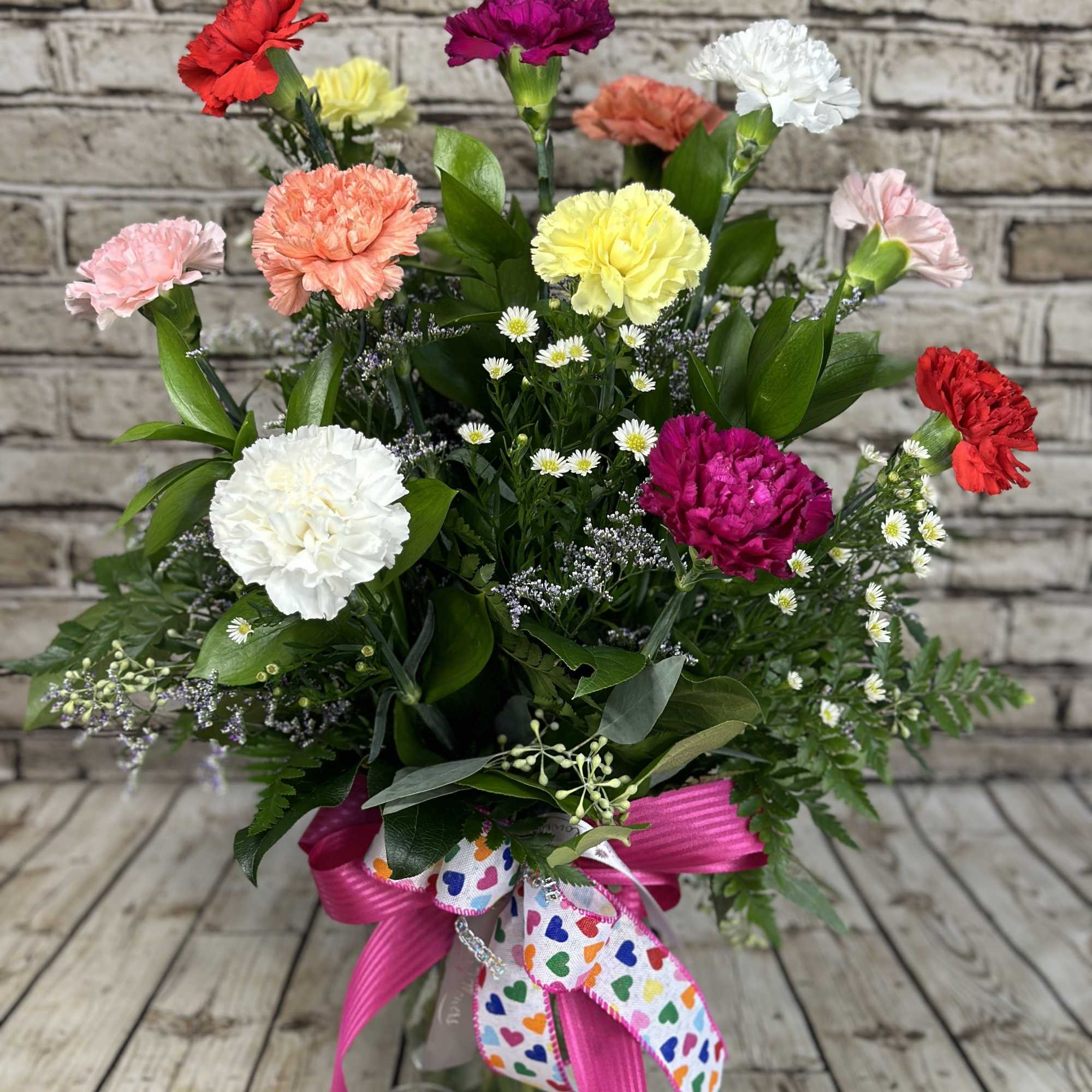 A wonderful and classic bouquet of carnations. Twelve (12) stems adorn the
