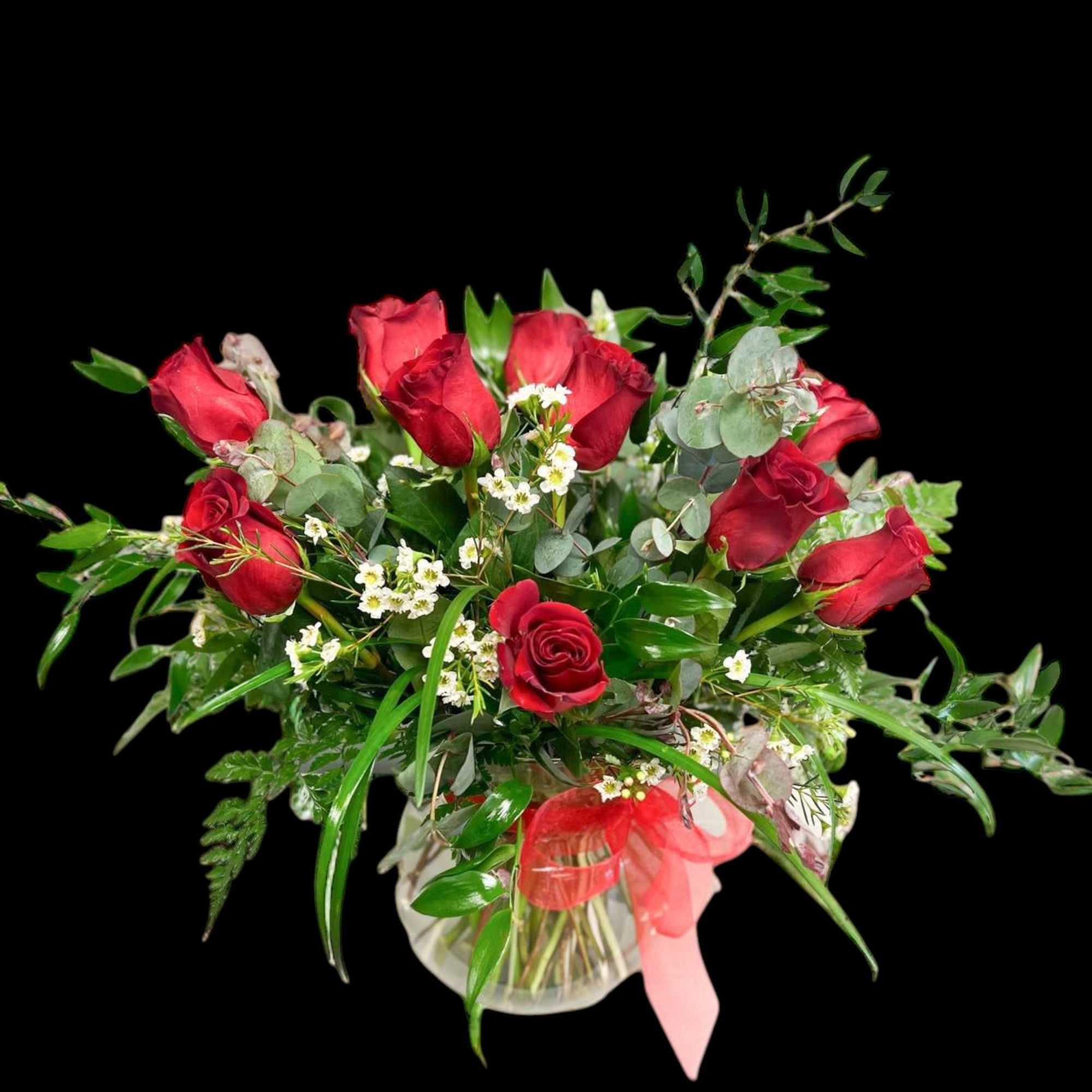 12 Red roses accented with premium greens in a  clear vase.