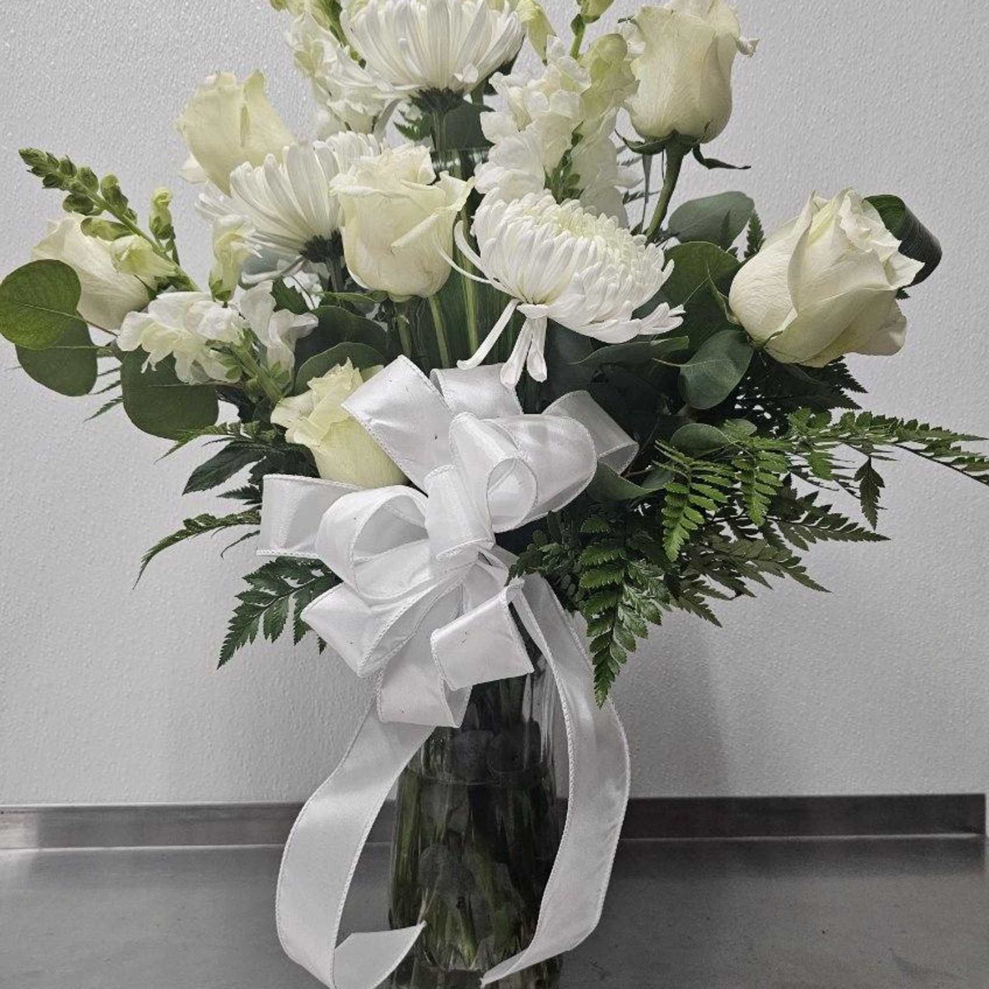 One sided vase to enjoy anywhere.  All white flowers including roses.