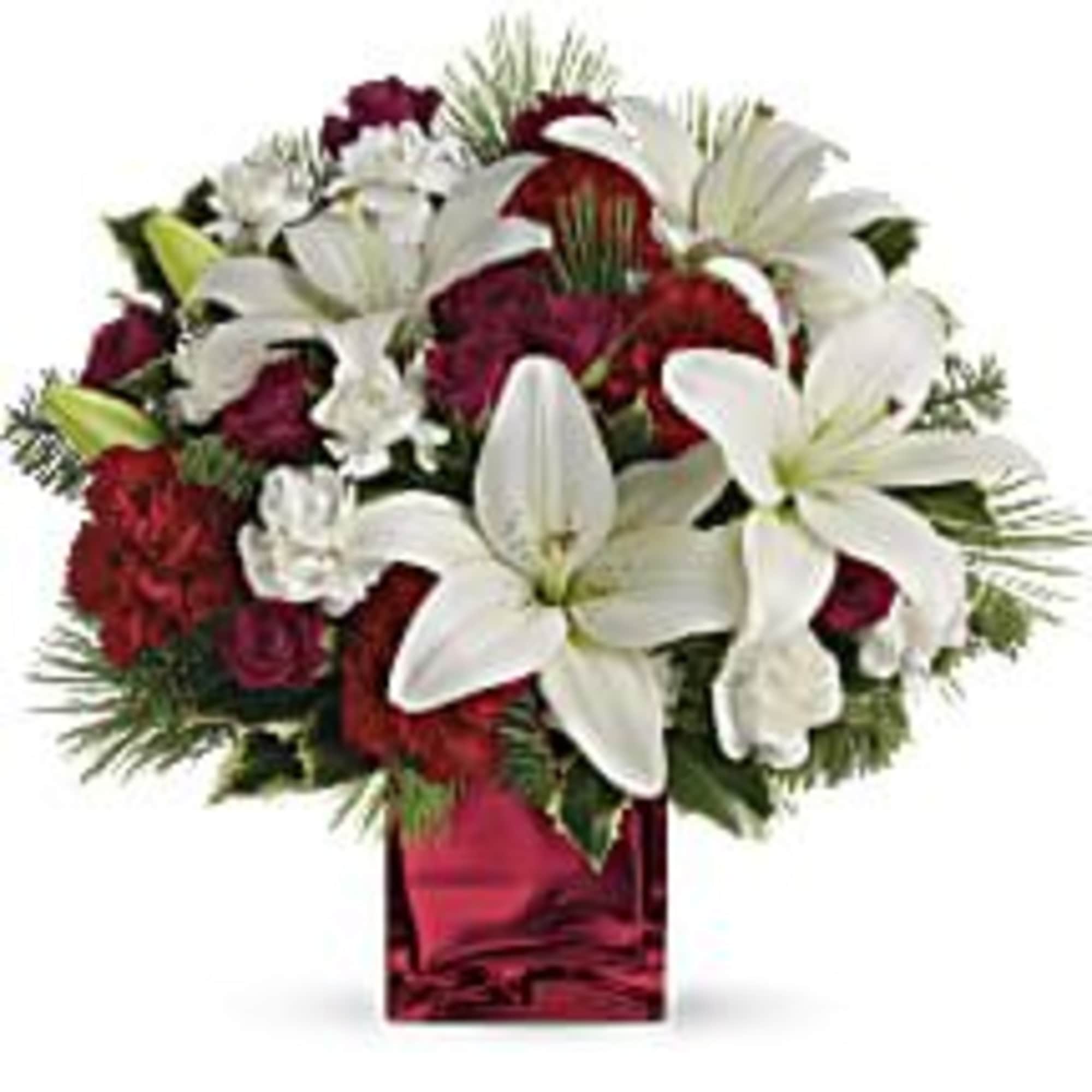 This festive holiday bouquet includes red roses and white Asiatic lilies presented