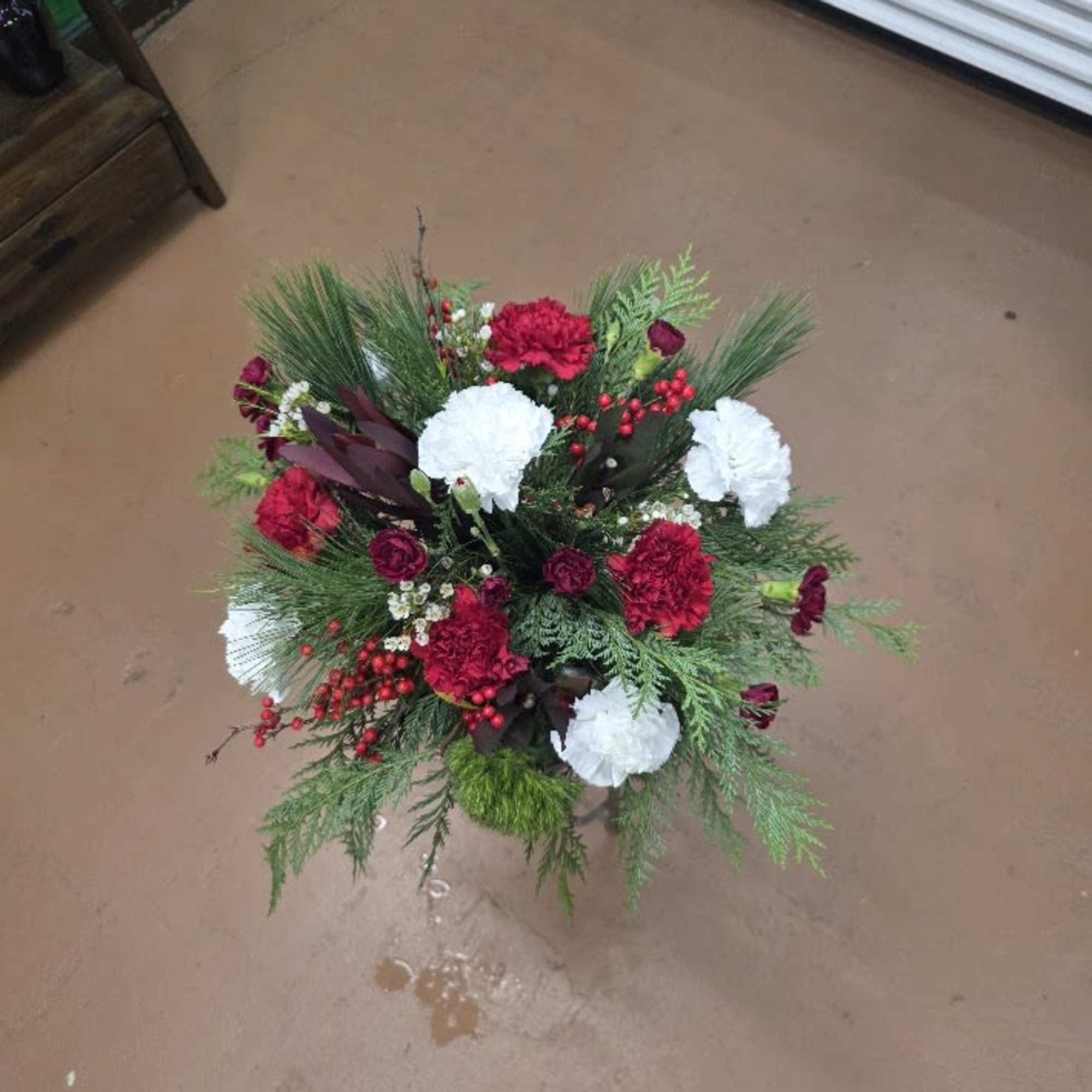 A festive blend of deep red and crisp white blooms accented with