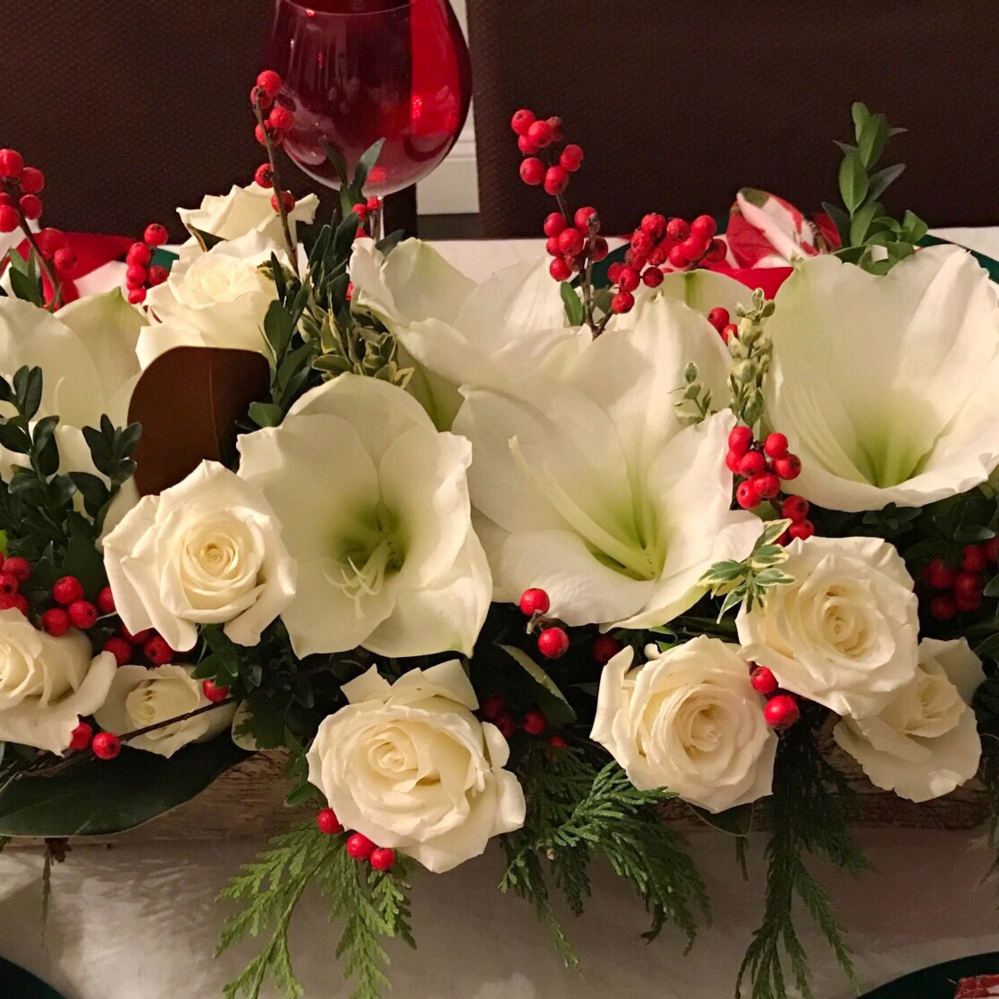 Amaryllis arranged in a oblong centerpiece style. color may vary with daily