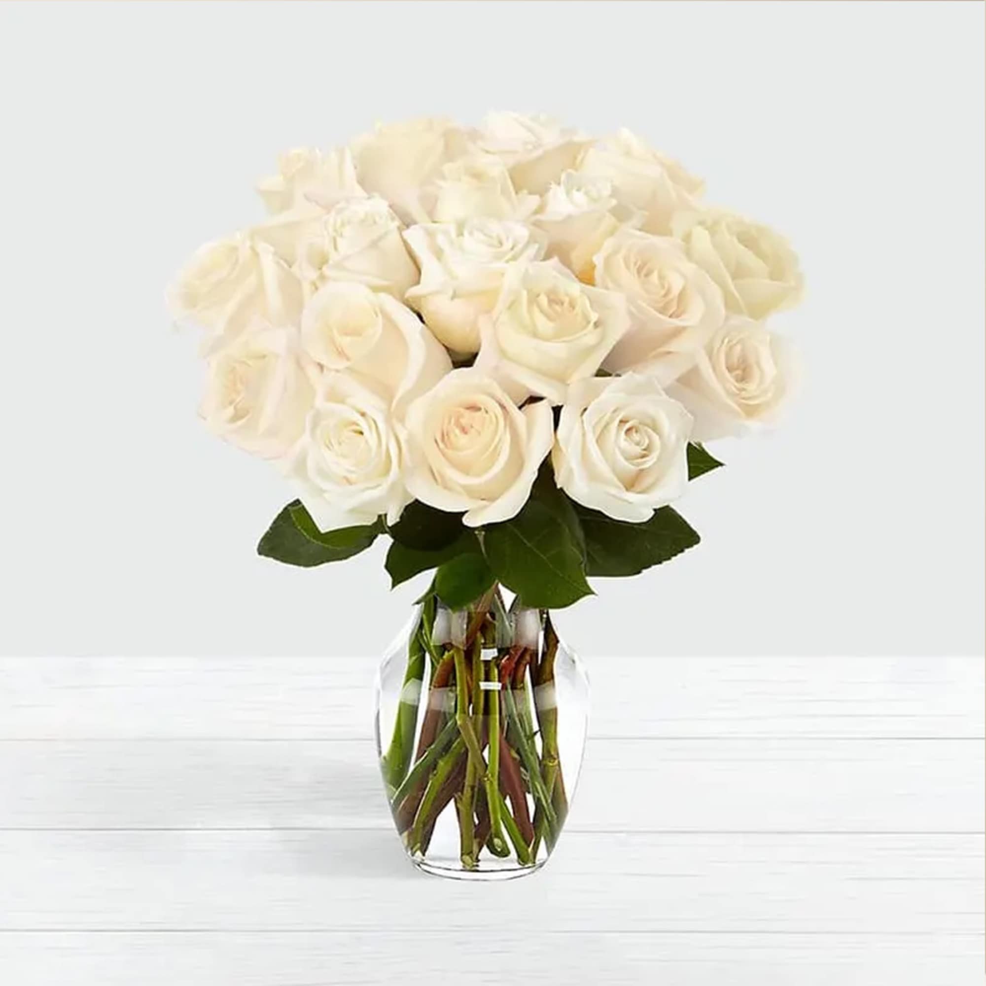 Standard White Roses Bouquet crafted in a simple glass vase that creates