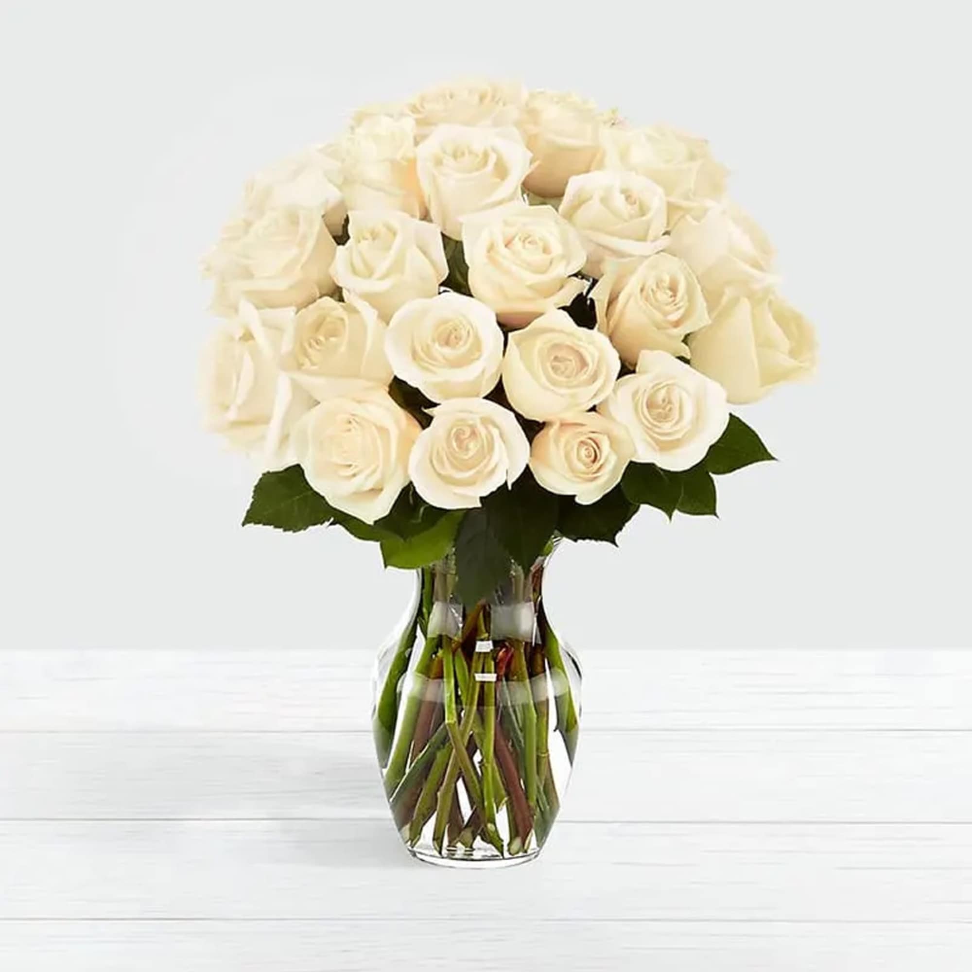 Standard White Roses Bouquet crafted in a simple glass vase that creates