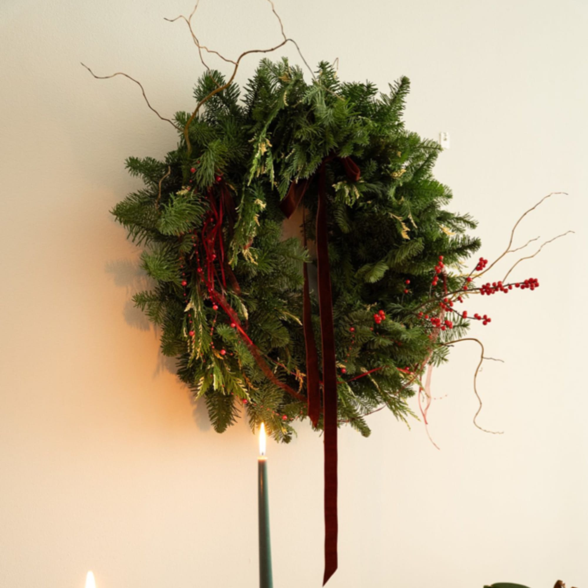 A lush and timeless Christmas wreath designed with premium, fresh winter greens