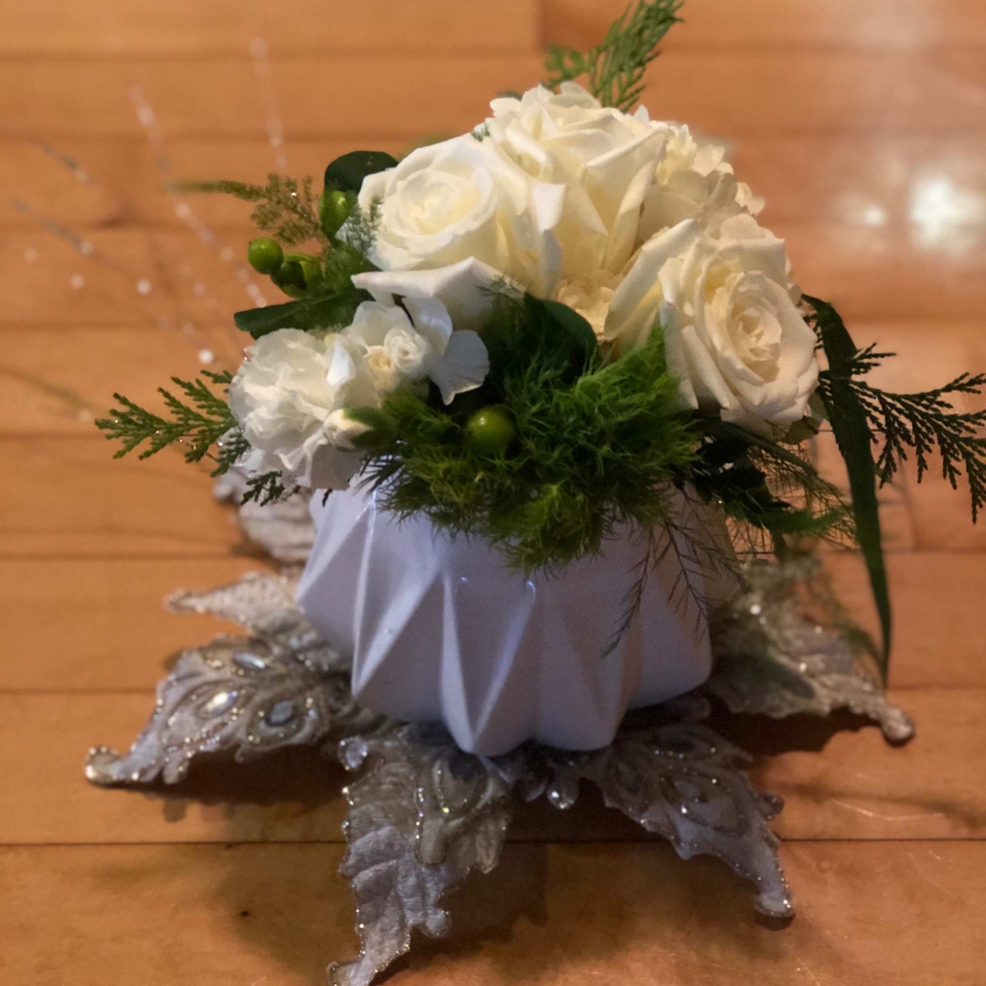 A one-of-kind custom creation. A white ceramic container is decorated with silk