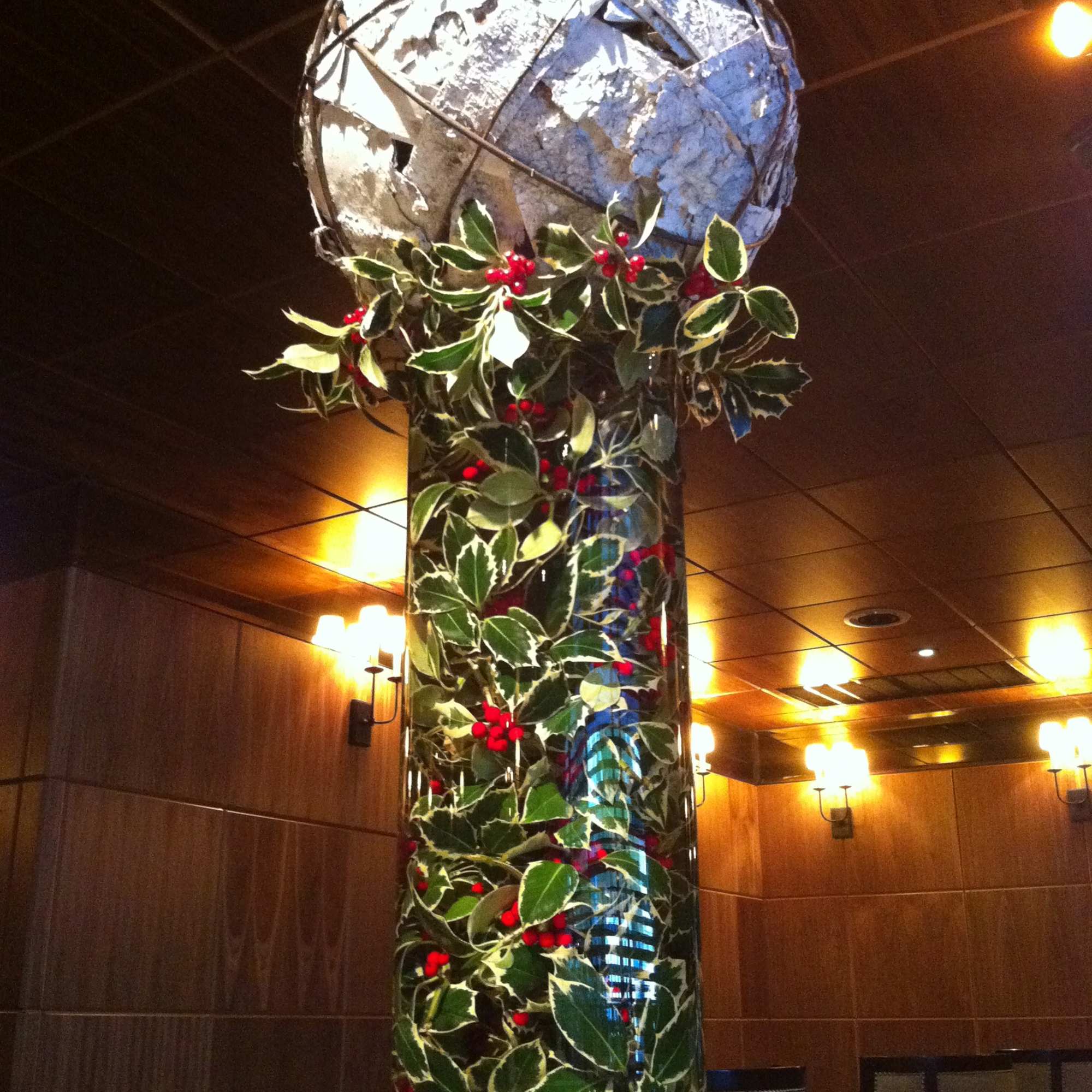 Oversized White Birch ball is sits a top of a tall vase