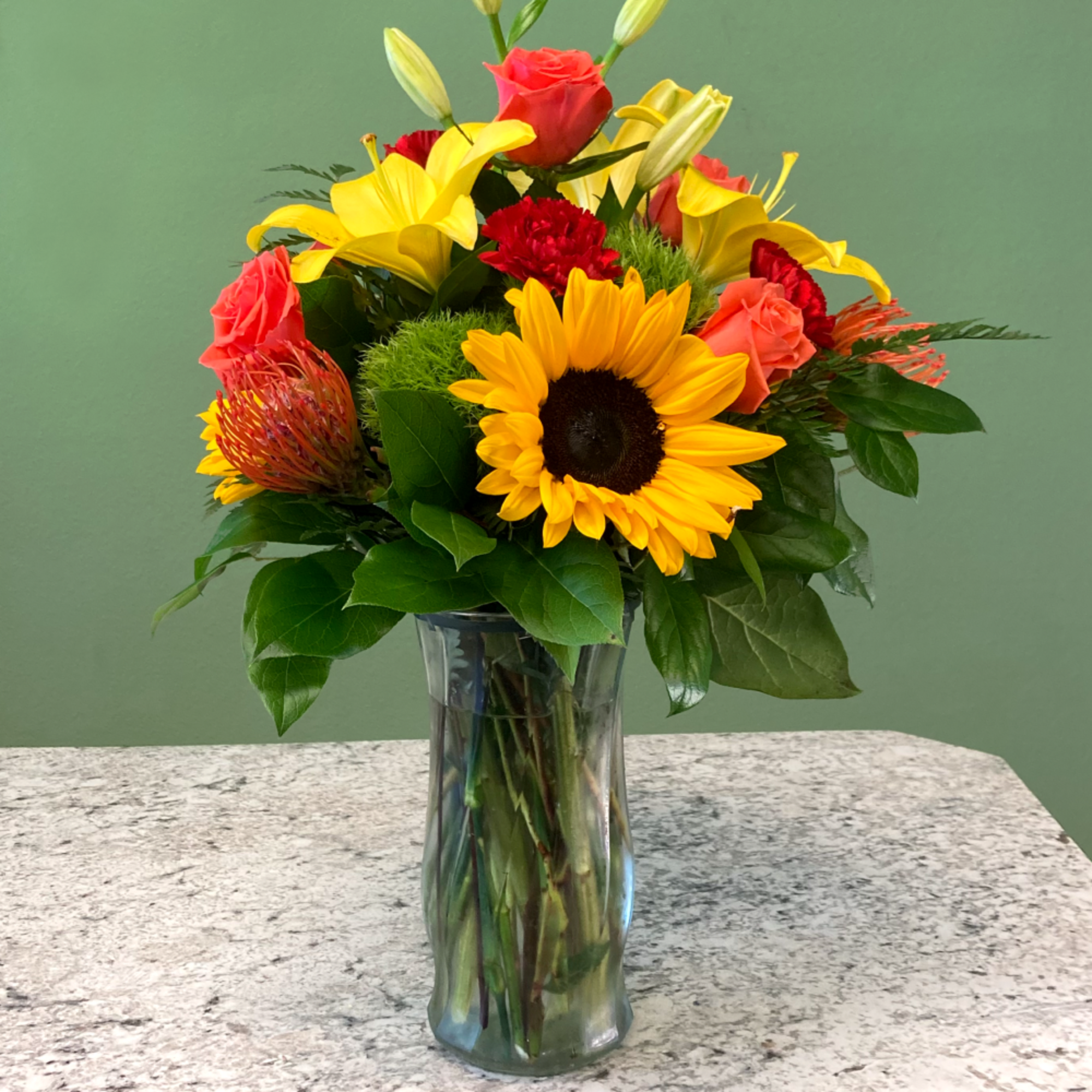 A spirited mixed arrangement showcasing vibrant shades of red, orange and yellow.