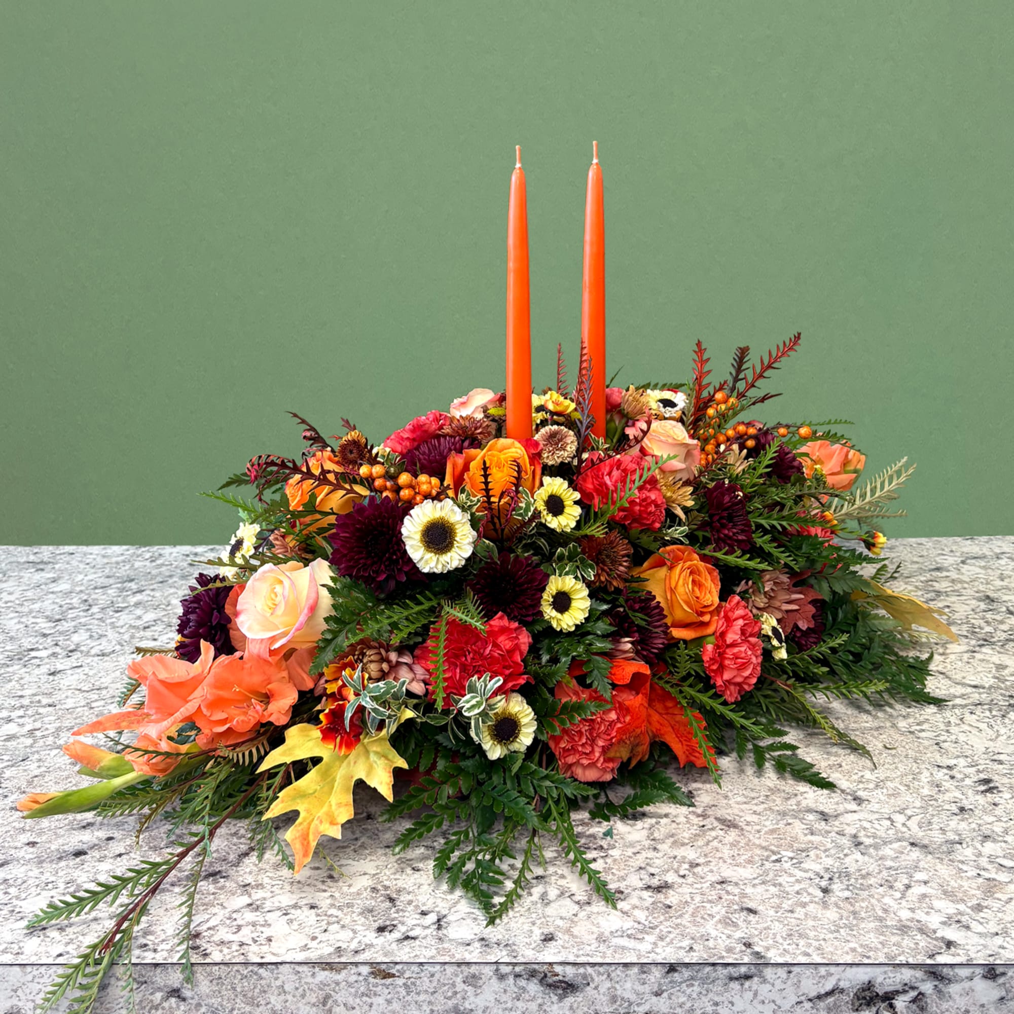 A warm and inviting long seasonal centerpiece. Showcasing an autumnal palette featuring