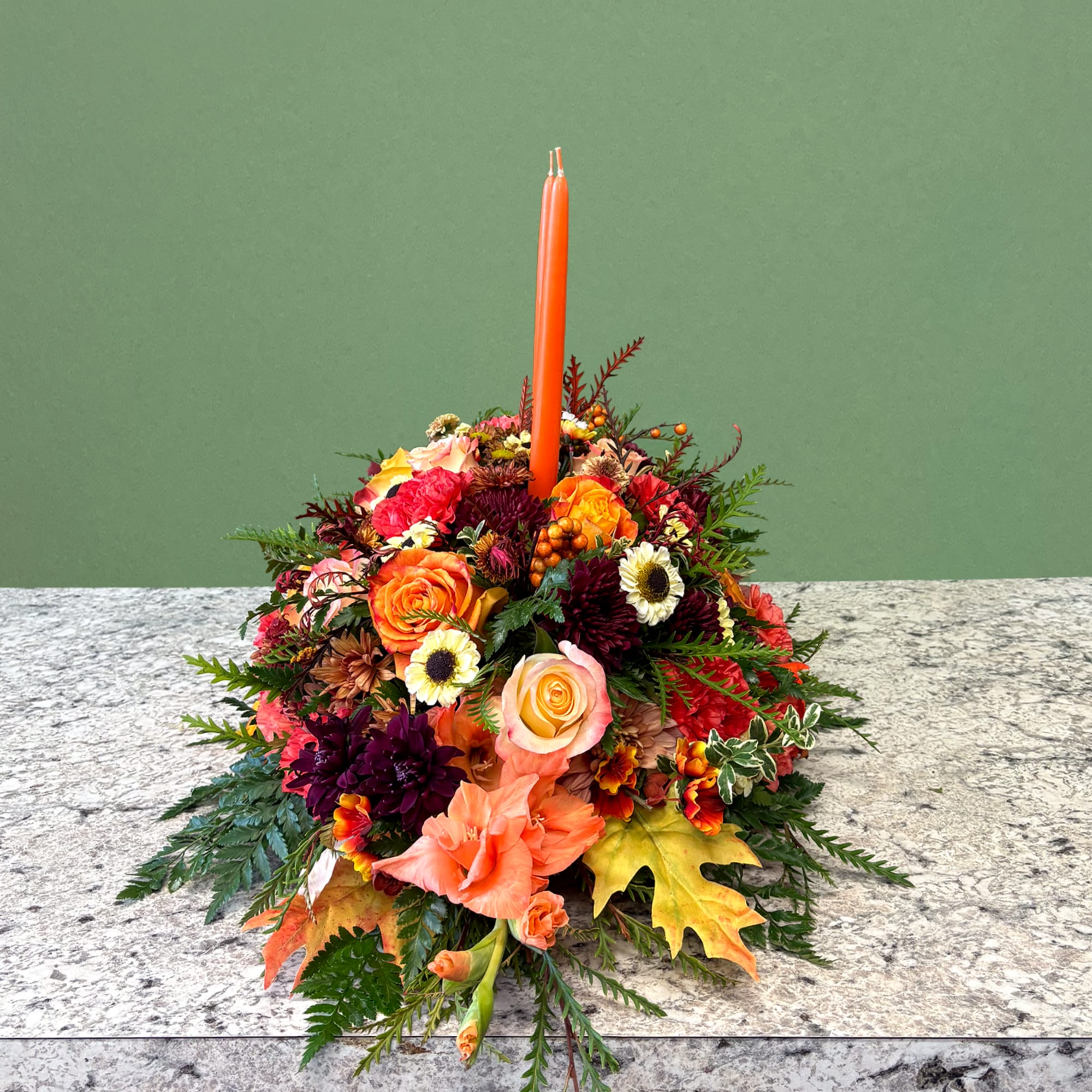 A warm and inviting long seasonal centerpiece. Showcasing an autumnal palette featuring