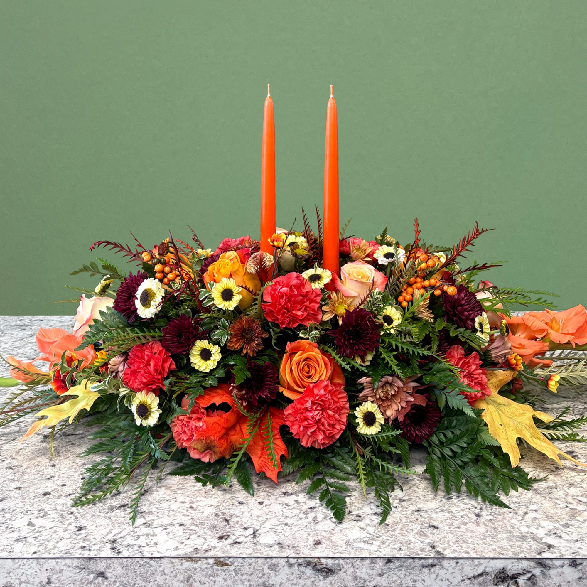 A warm and inviting long seasonal centerpiece. Showcasing an autumnal palette featuring