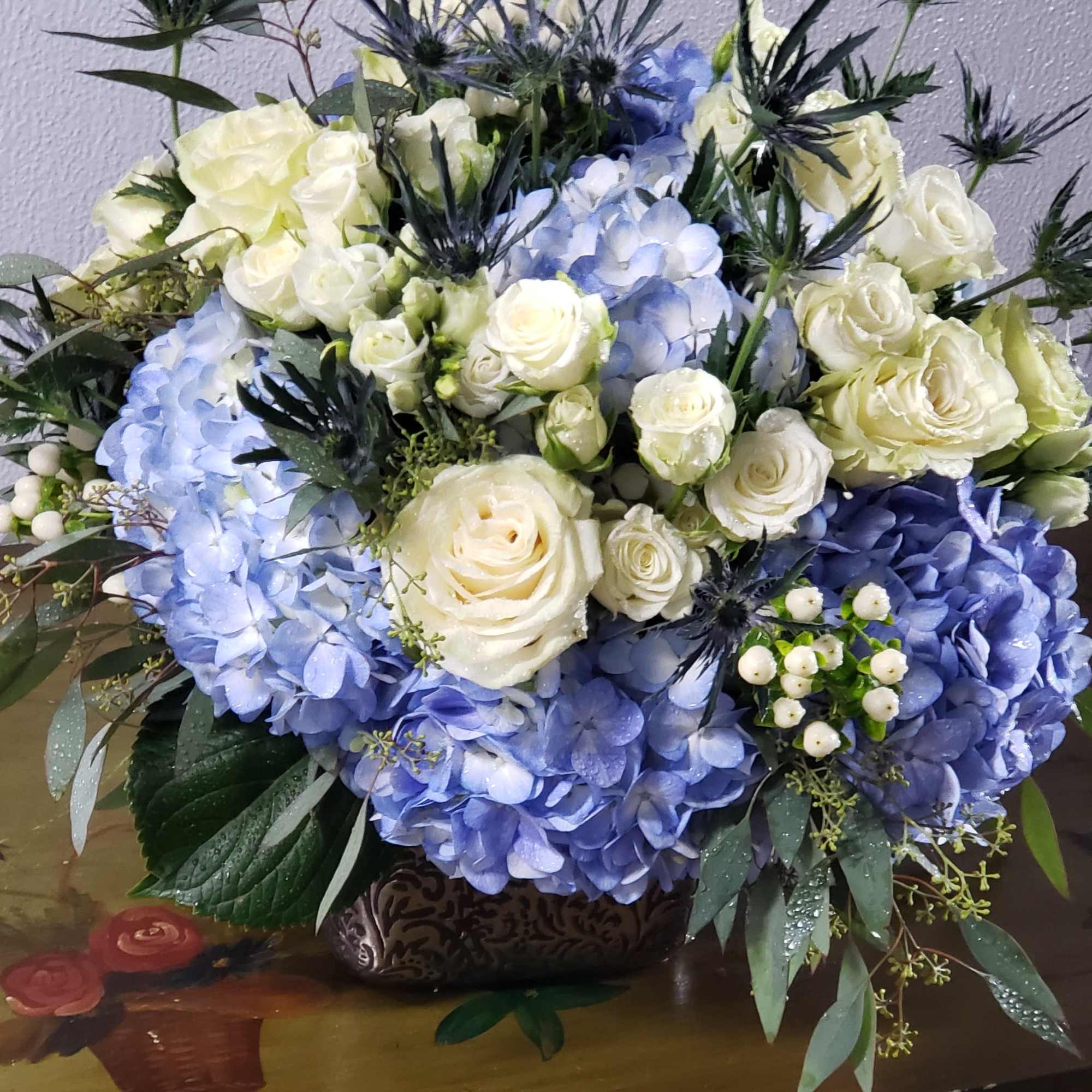  Elegant copper cube, filled with perry winkle blue hydrangea blooms,white roses