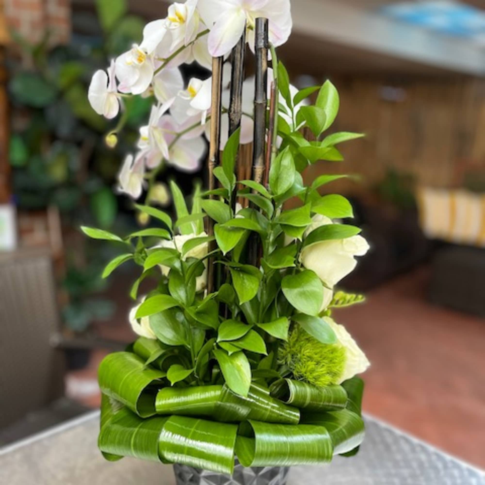 The Ch&eacute;rie Orchids and Tulip Arrangement is a striking display of elegance