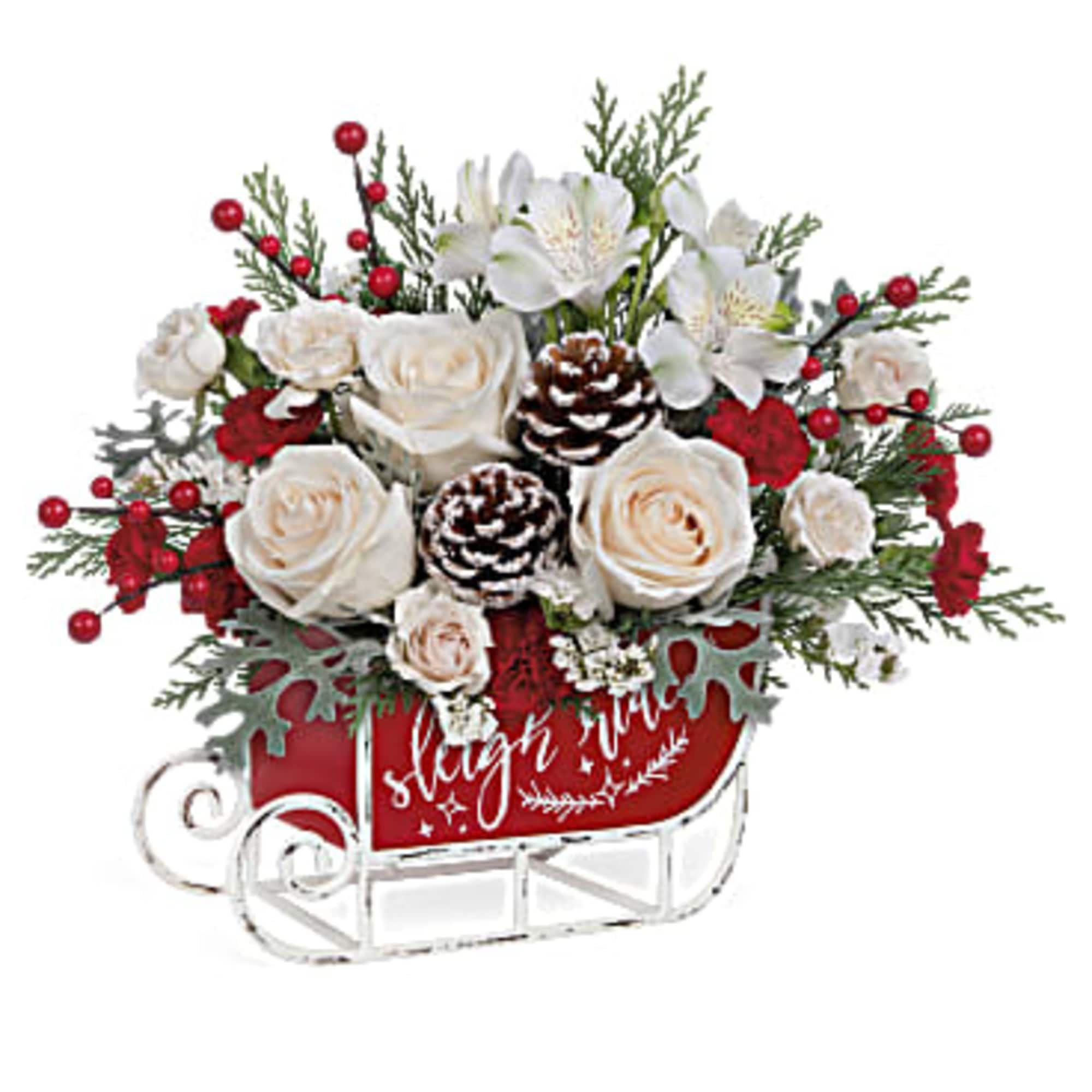 This cute Christmas bouquet of snow white roses and flocked greens becomes