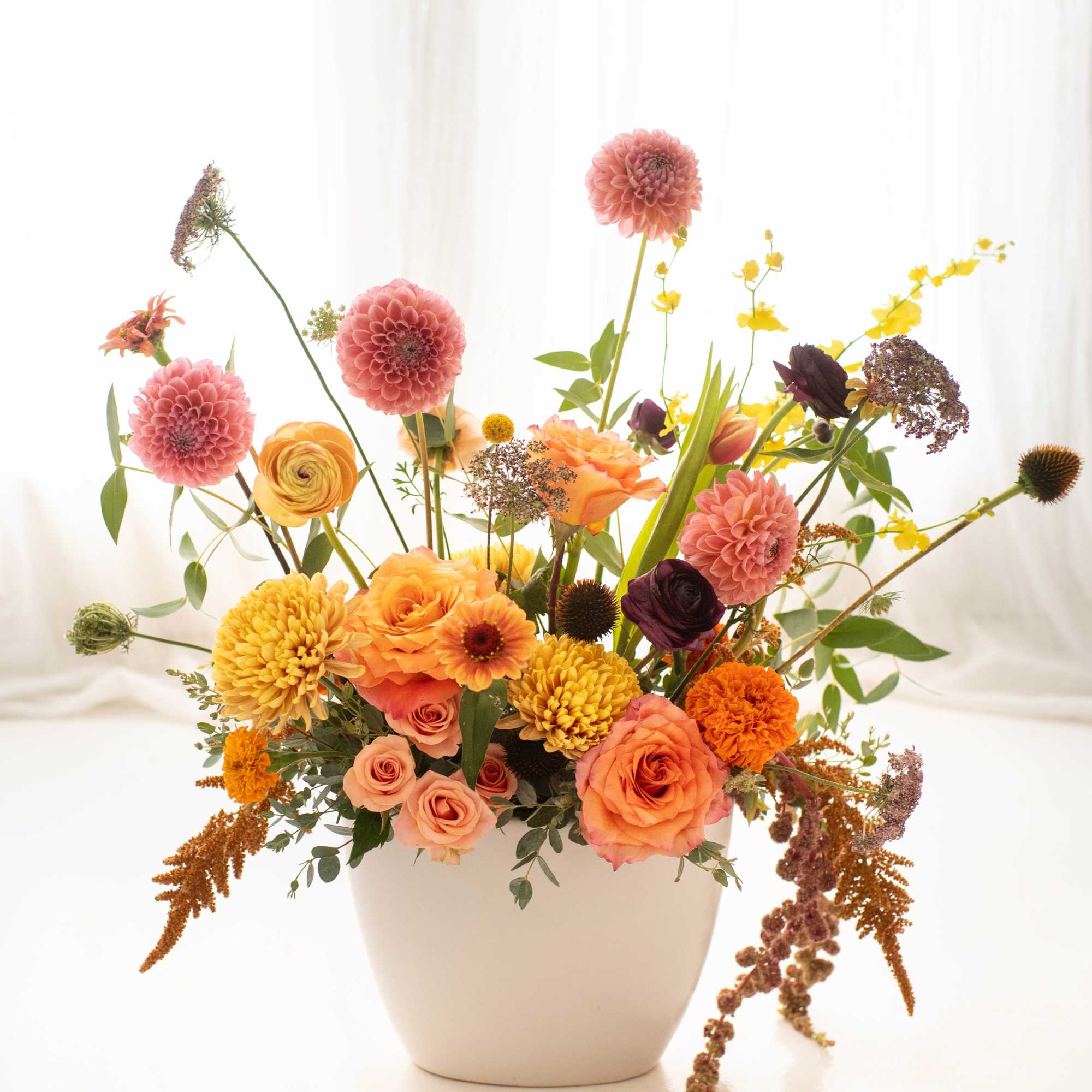 A striking blend of premium fall blooms artfully arranged in a sleek