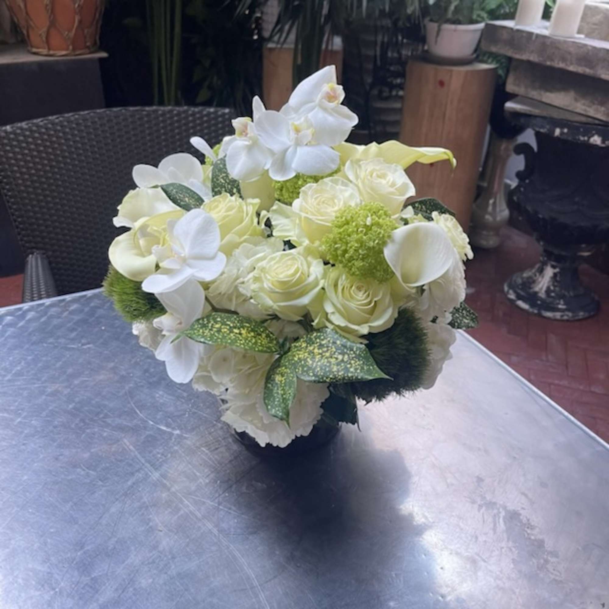 &quot;Snow White Serenity&quot; is an enchanting flower arrangement that captures the pristine