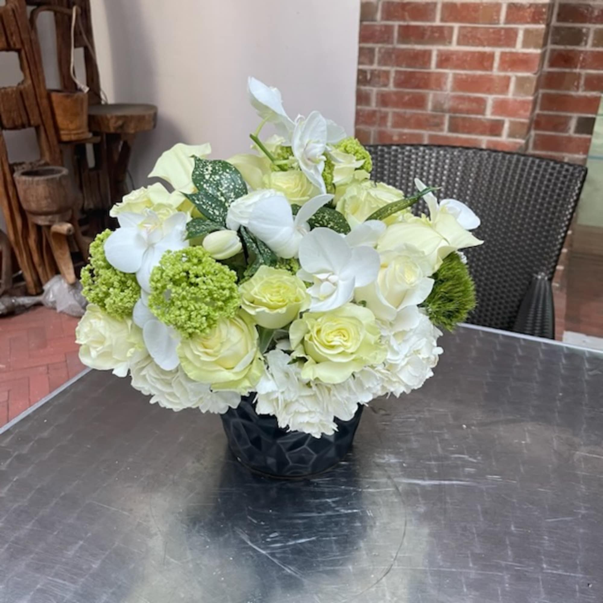 &quot;Snow White Serenity&quot; is an enchanting flower arrangement that captures the pristine