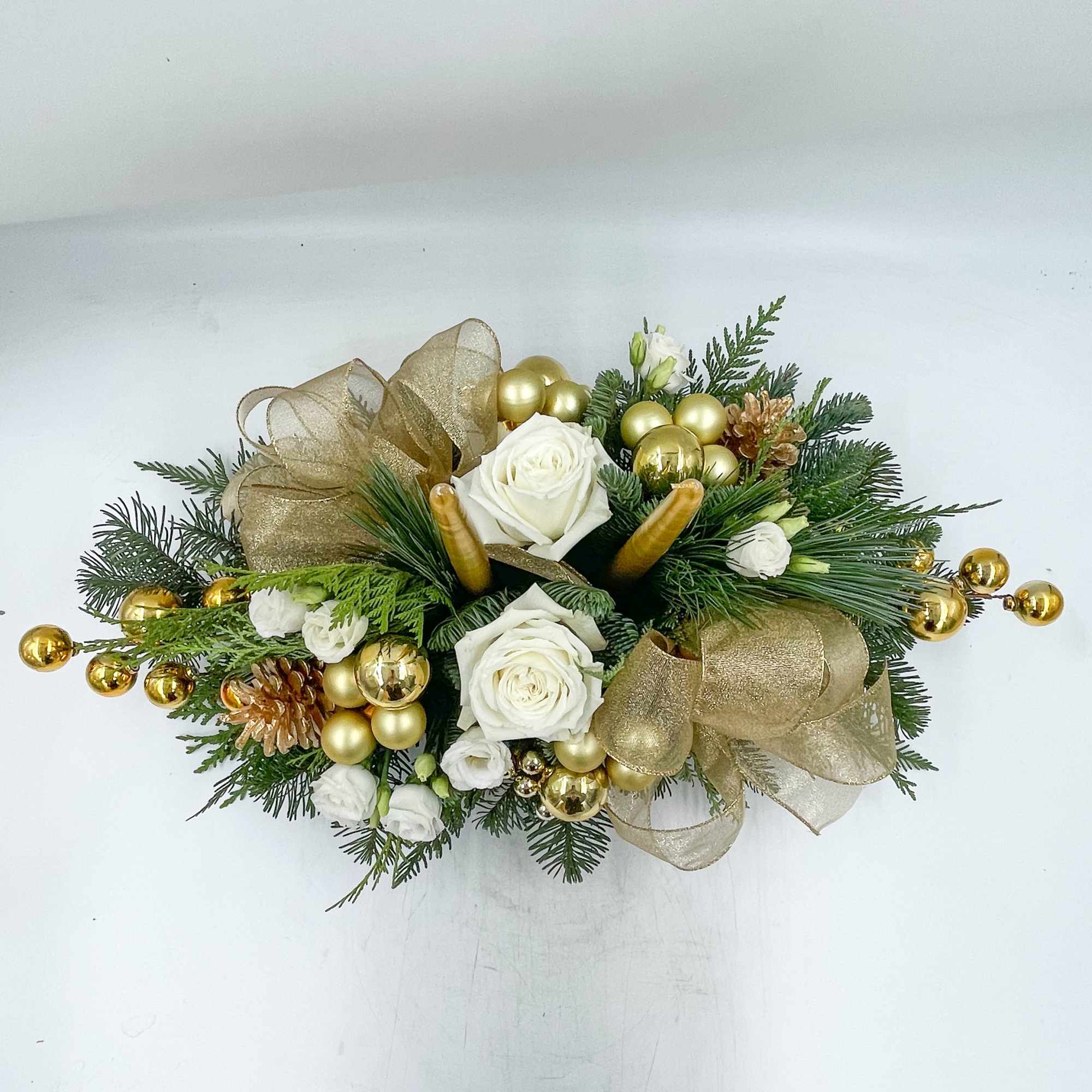 A beautiful gold and white Christmas Centerpiece, Christmas Dreaming features Gold Candles