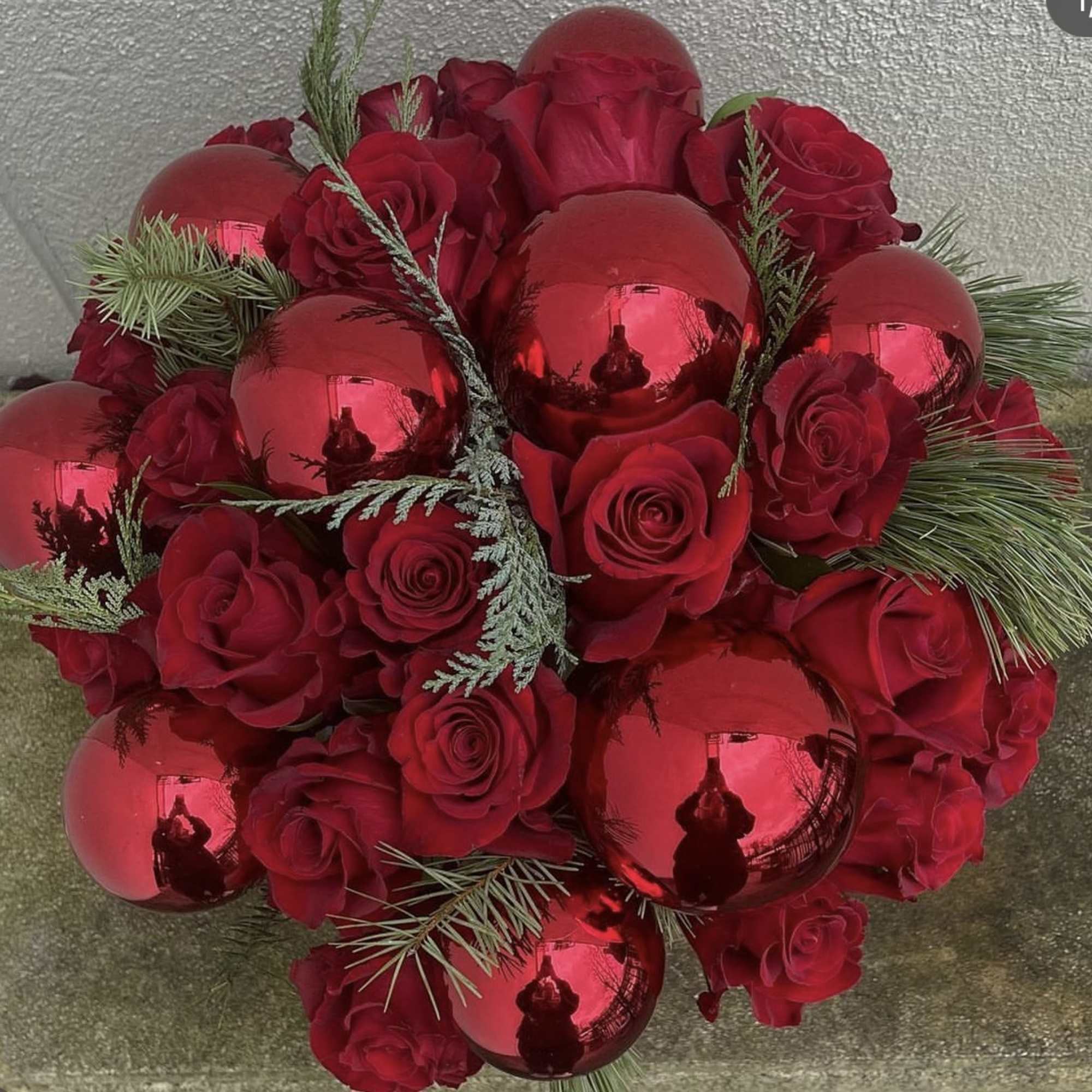 A gorgeous upscale rose bowl arrangement, Santa Baby features premium Red Roses