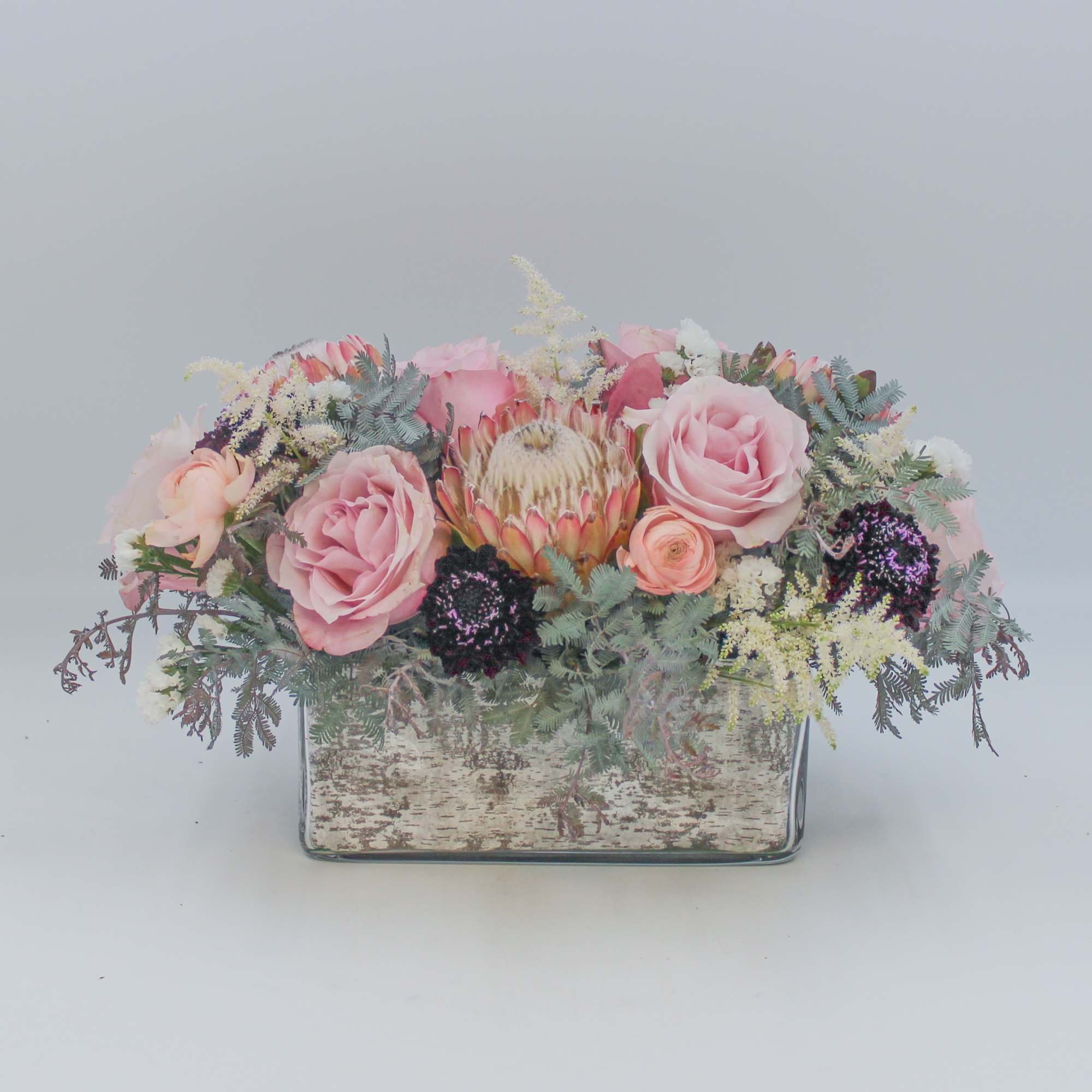 Sugar Plum Fairy is an incredible mix of Protea, Pink Roses, Plum