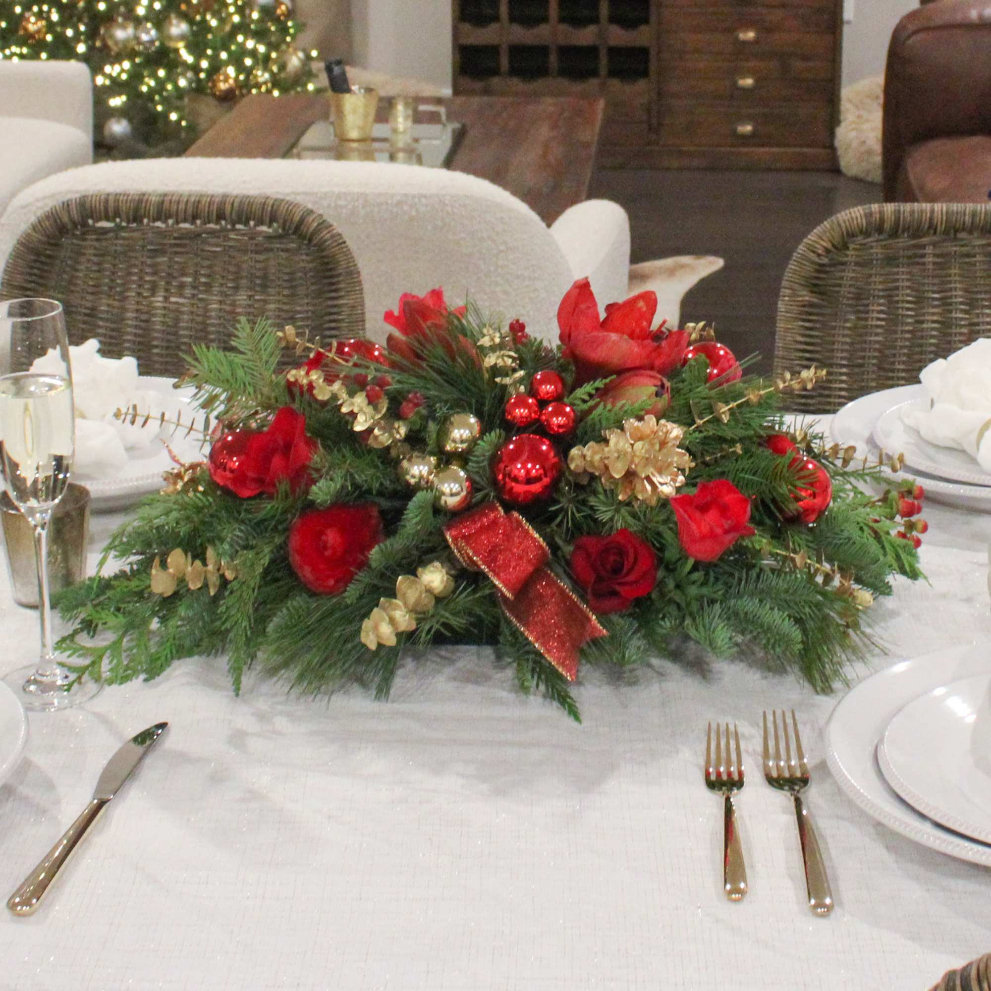 The Nutcracker is a traditional long and low centerpiece with Red Amaryllis