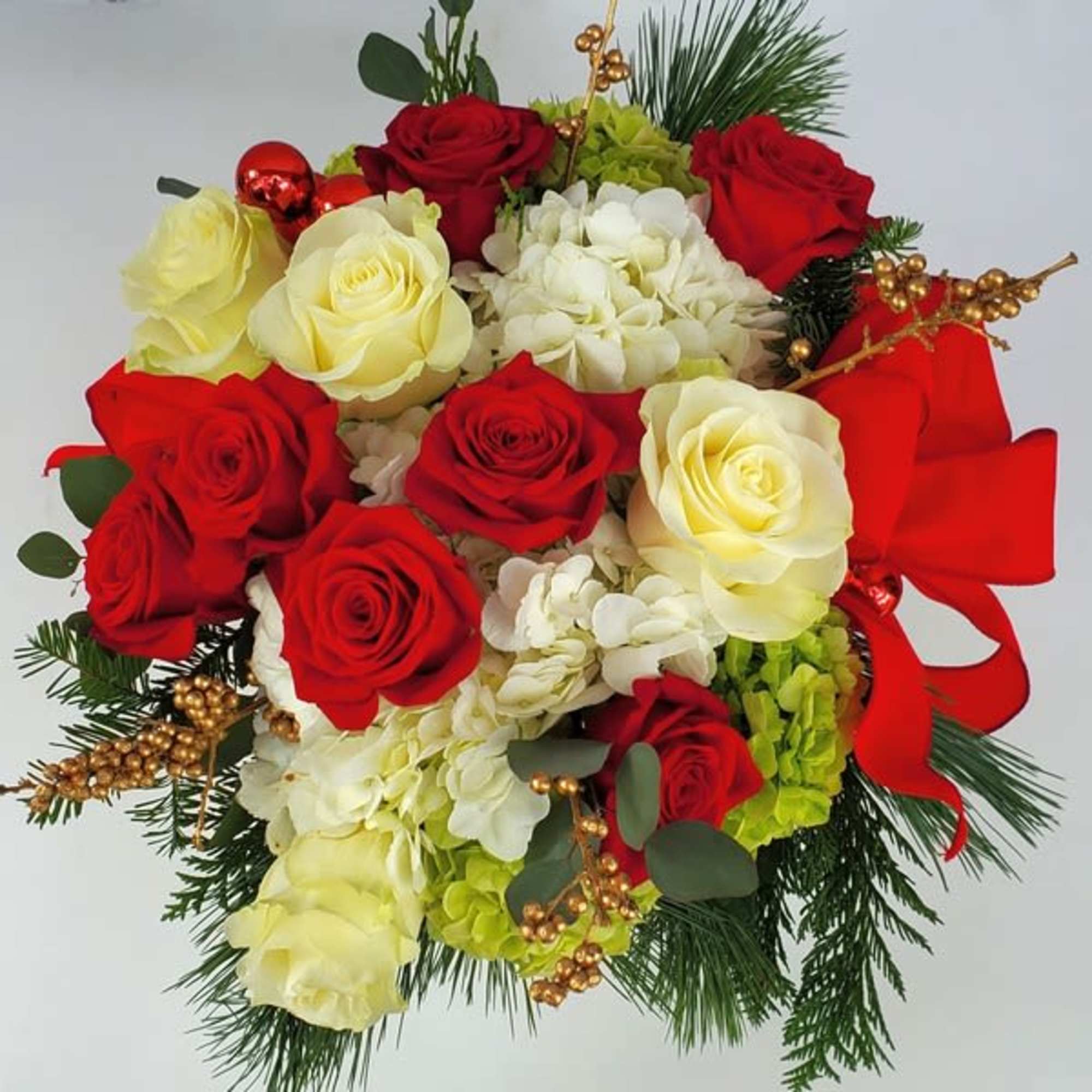Vase arrangement of premium red, white (and sometimes pink) flowers and berries