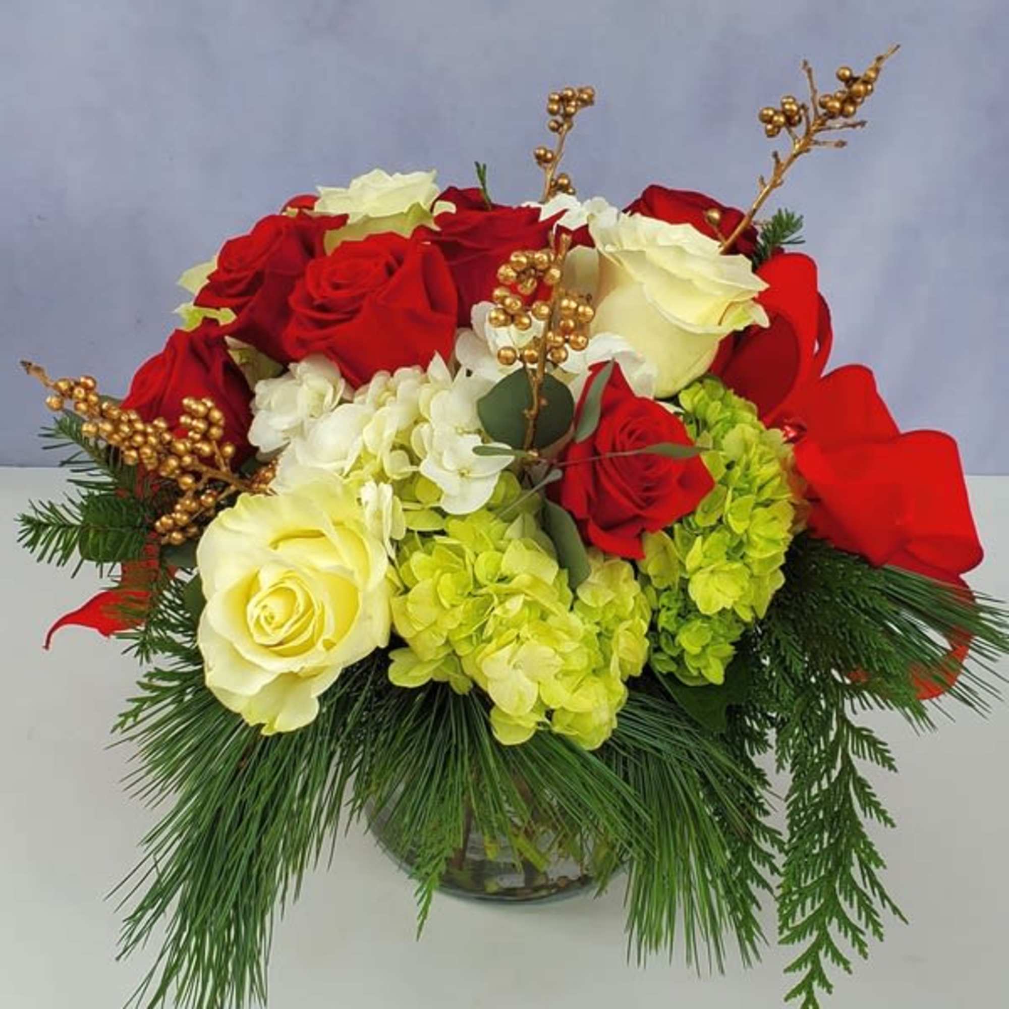 Vase arrangement of premium red, white (and sometimes pink) flowers and berries