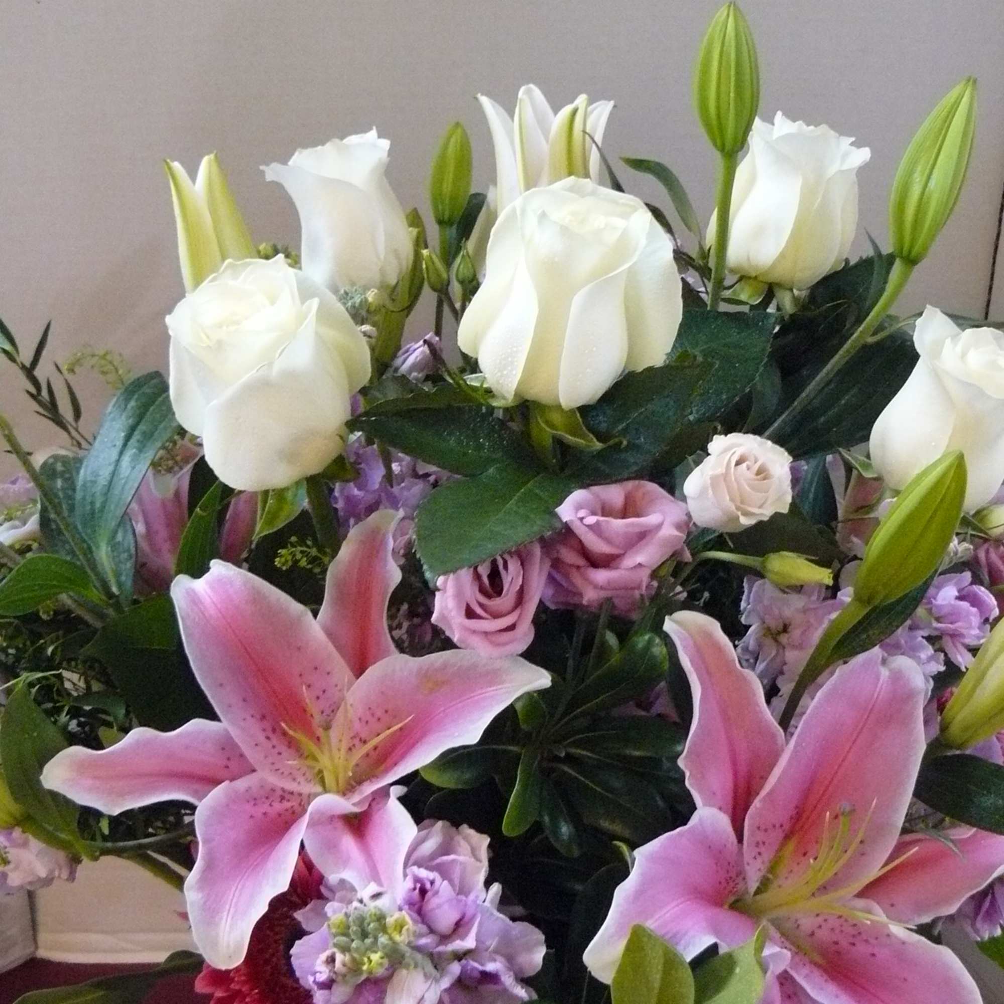 Lilies, Roses, Gerbera Daisies, Lisianthus, Stock, Fancy Greens 