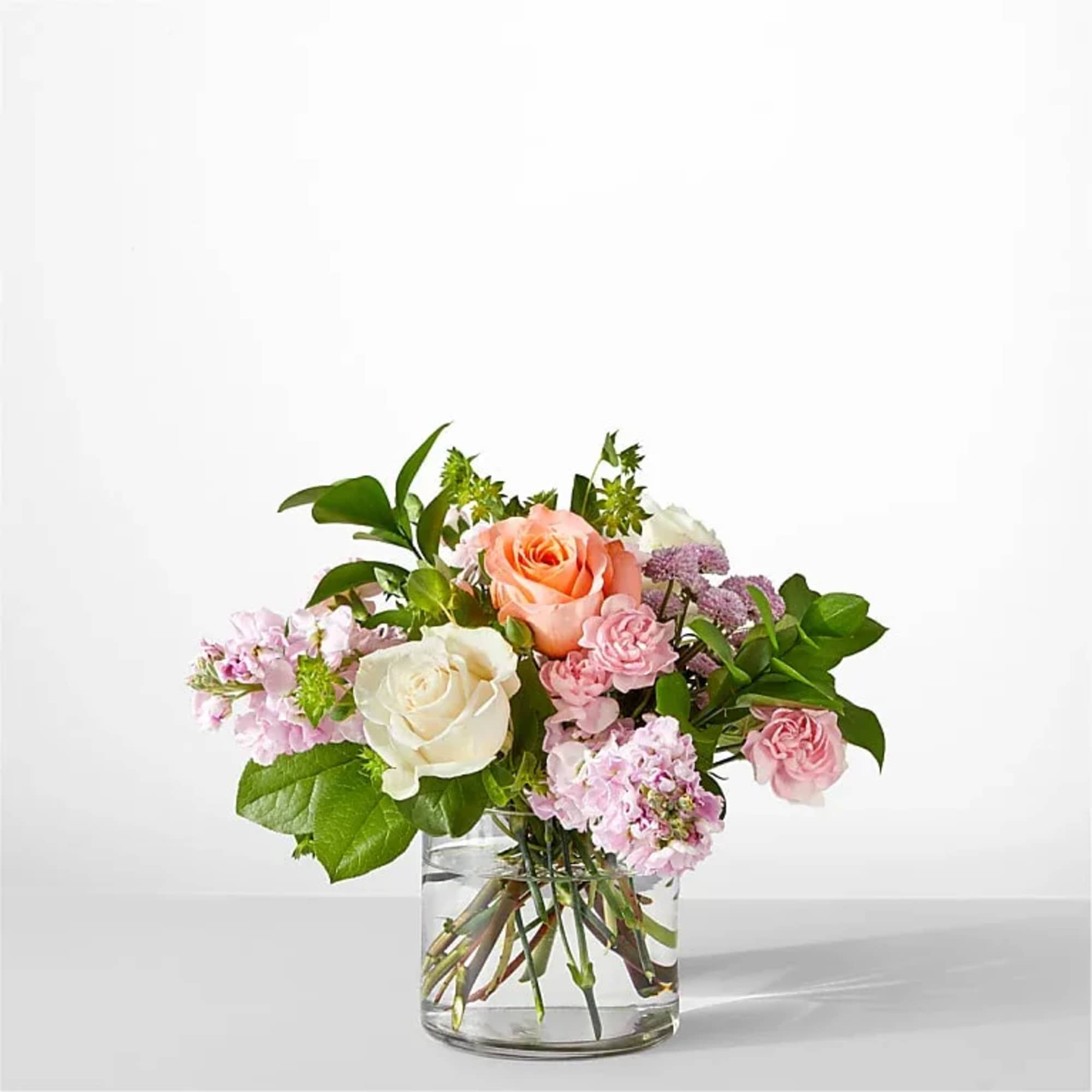 Serene and fragrant, this arrangement blends soft pastels to create a gift