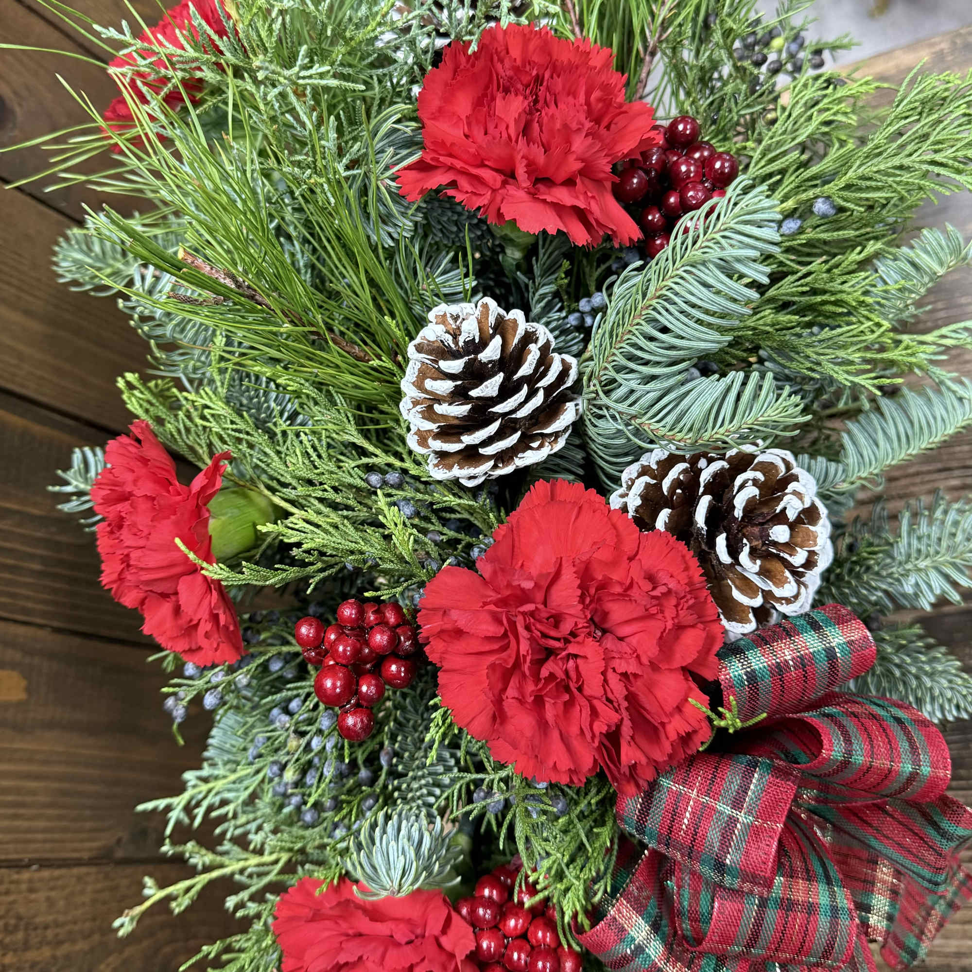 This stunning holiday arrangement is nestled inside a beautiful red and gold