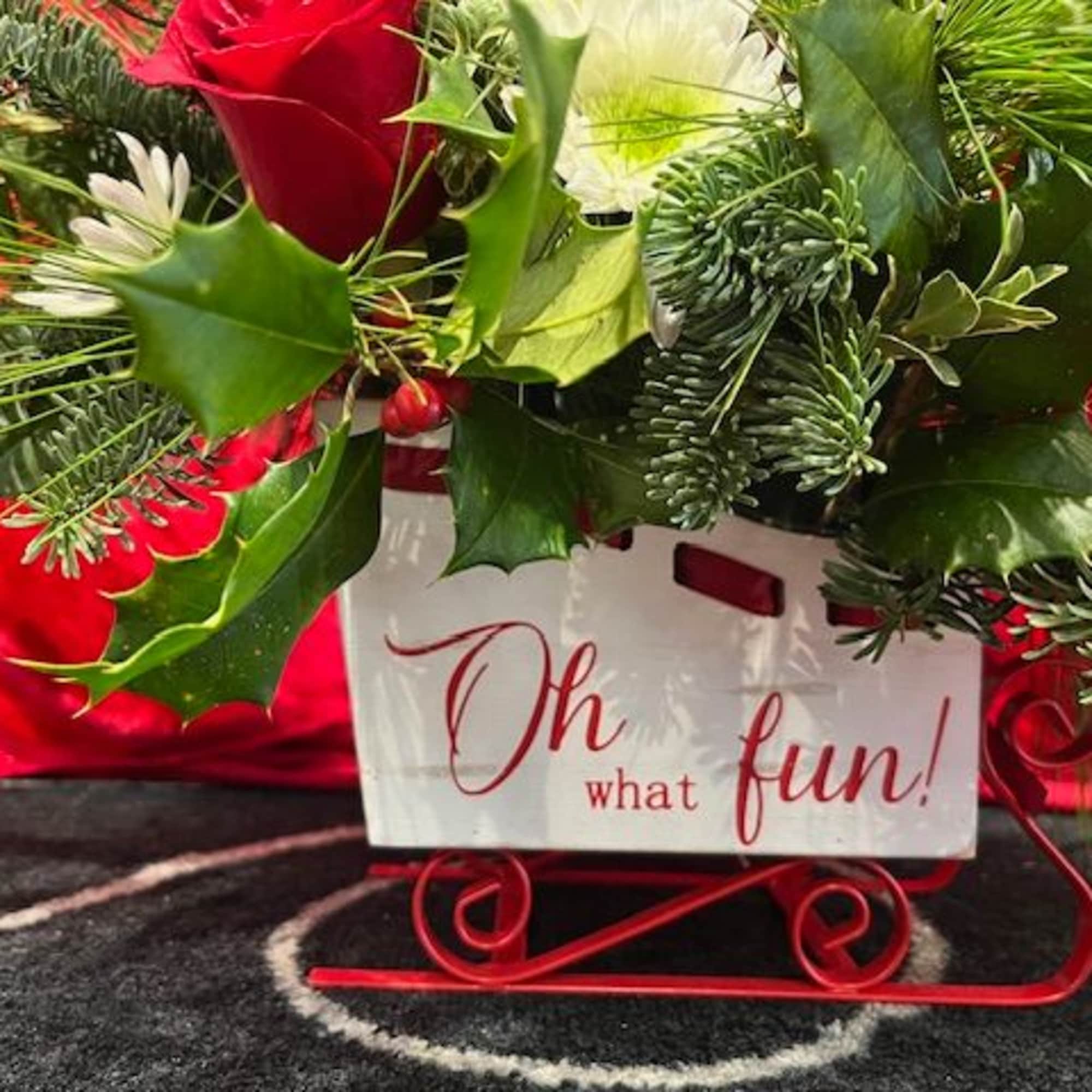 Sleigh Bells is designed in a charming white sleigh filled with winter