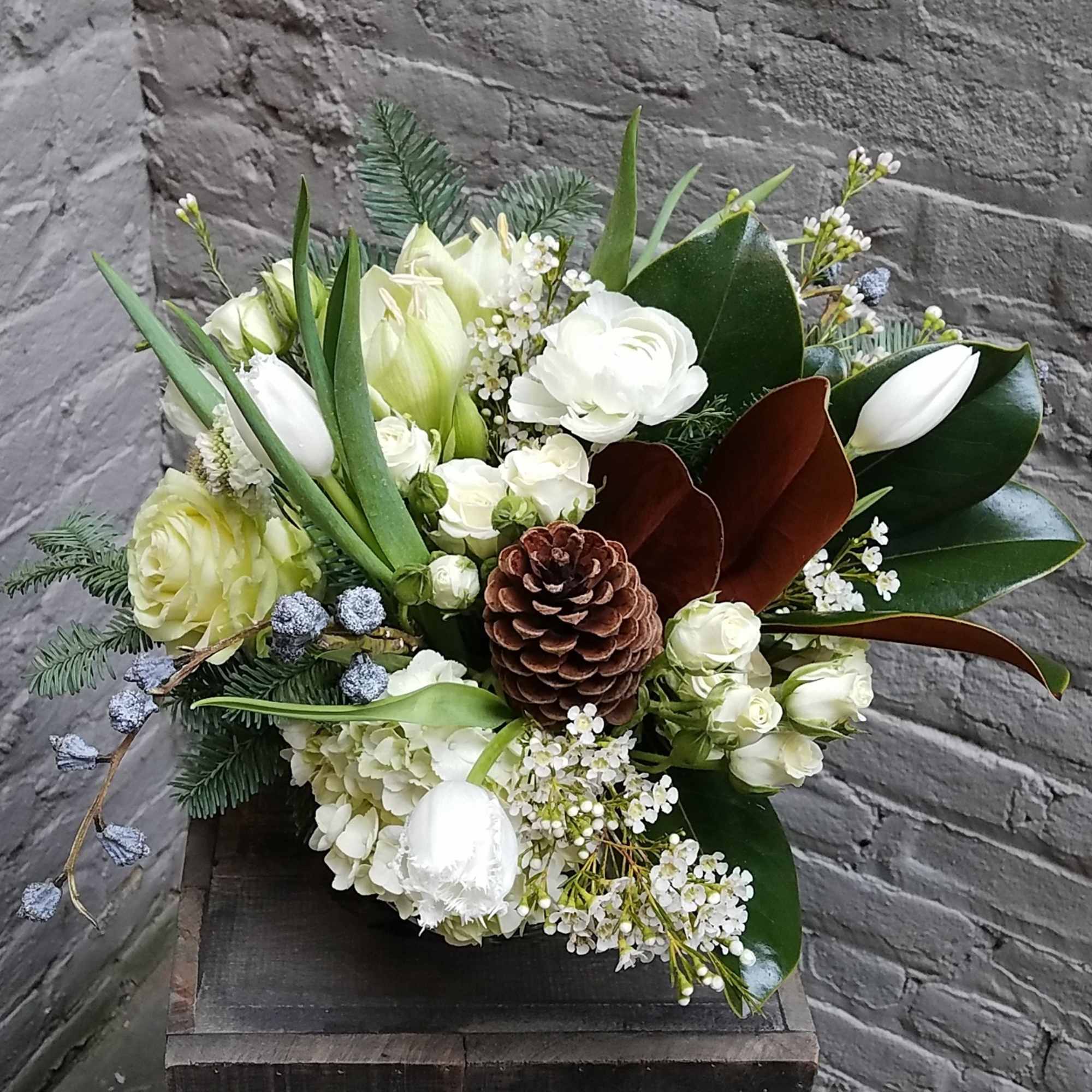 A clear glass vase filled to the brim with a collection of