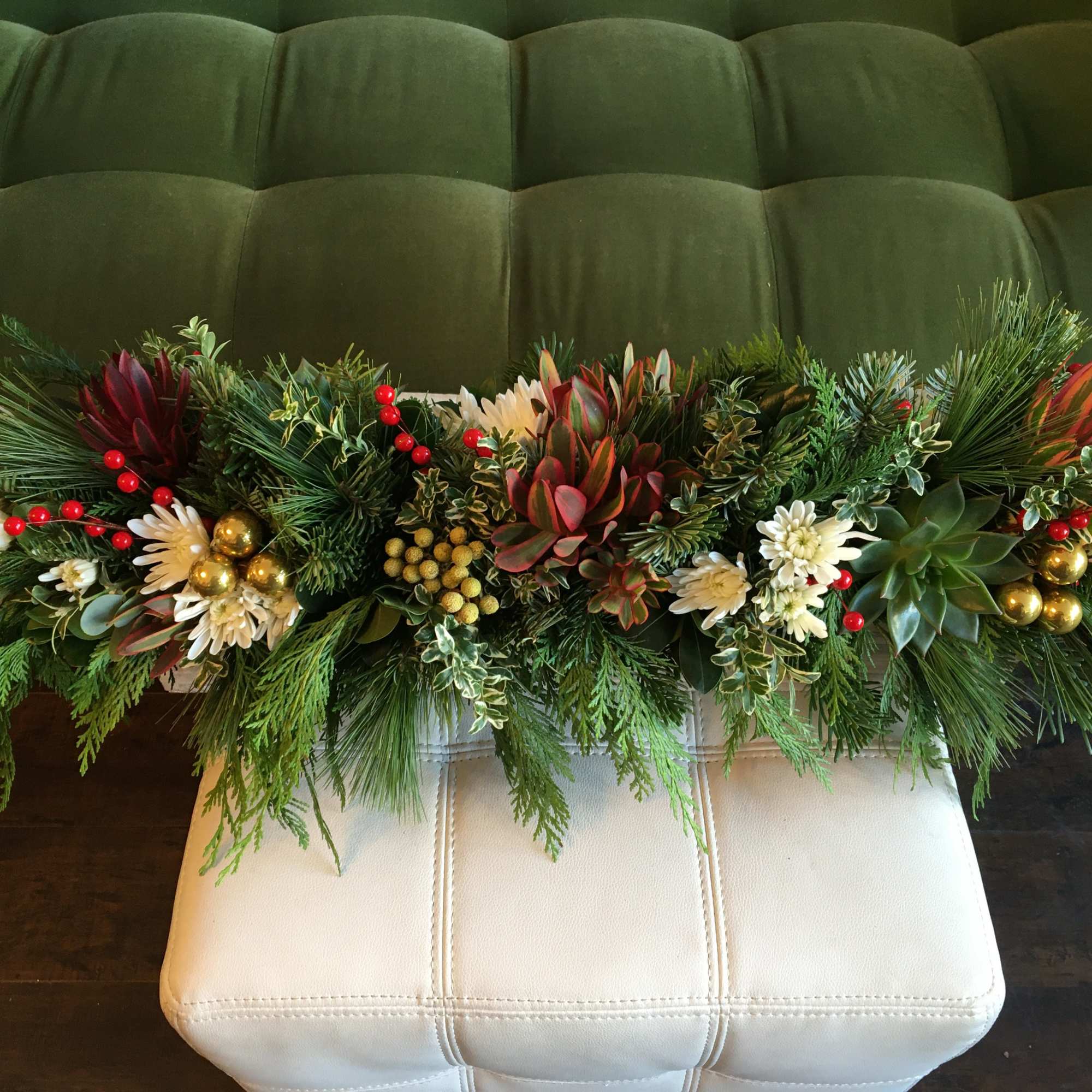 A Variety of Holiday Greenery with light holiday florals and accents. 