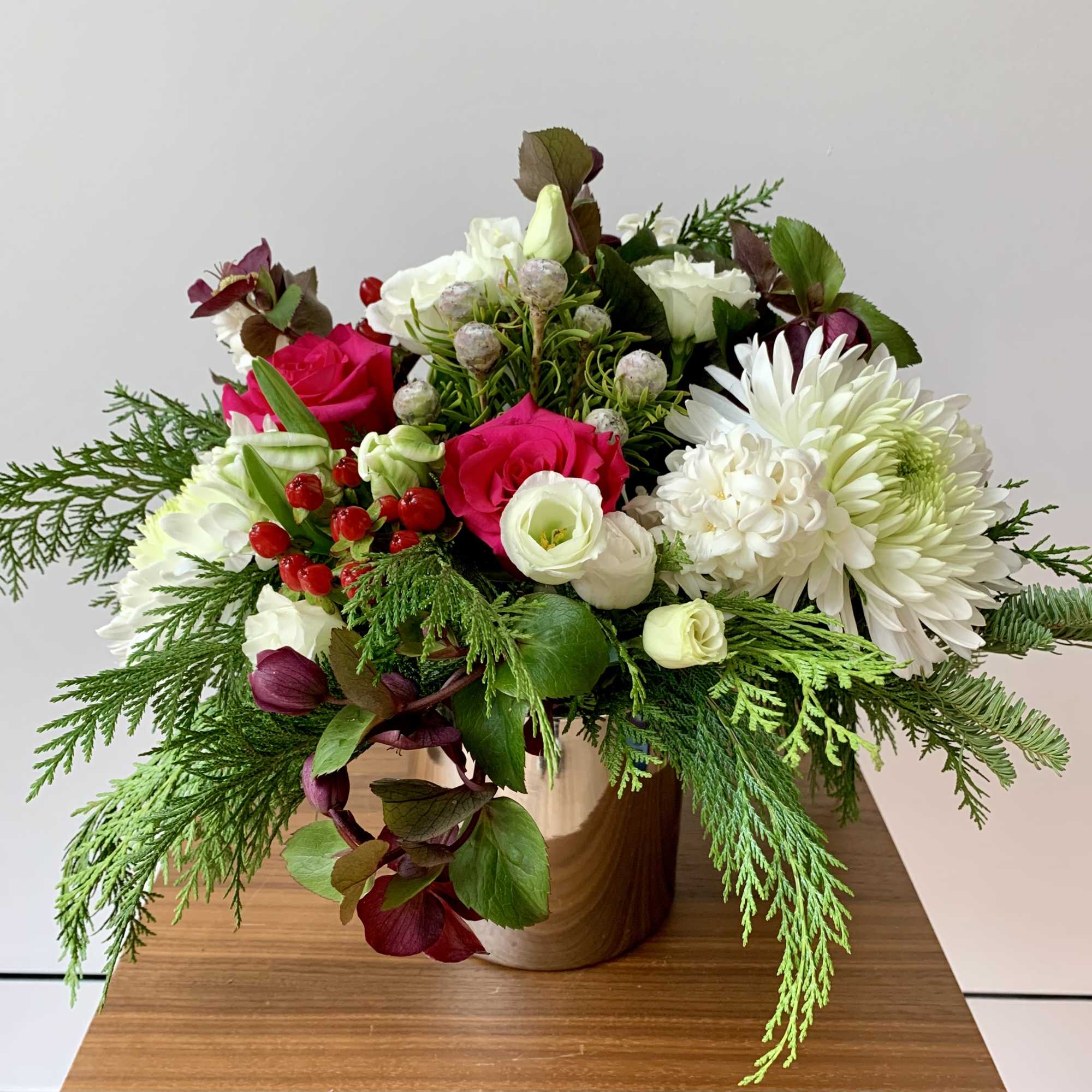 Lovely flower arrangement in a shiny cylinder vase with a variety of