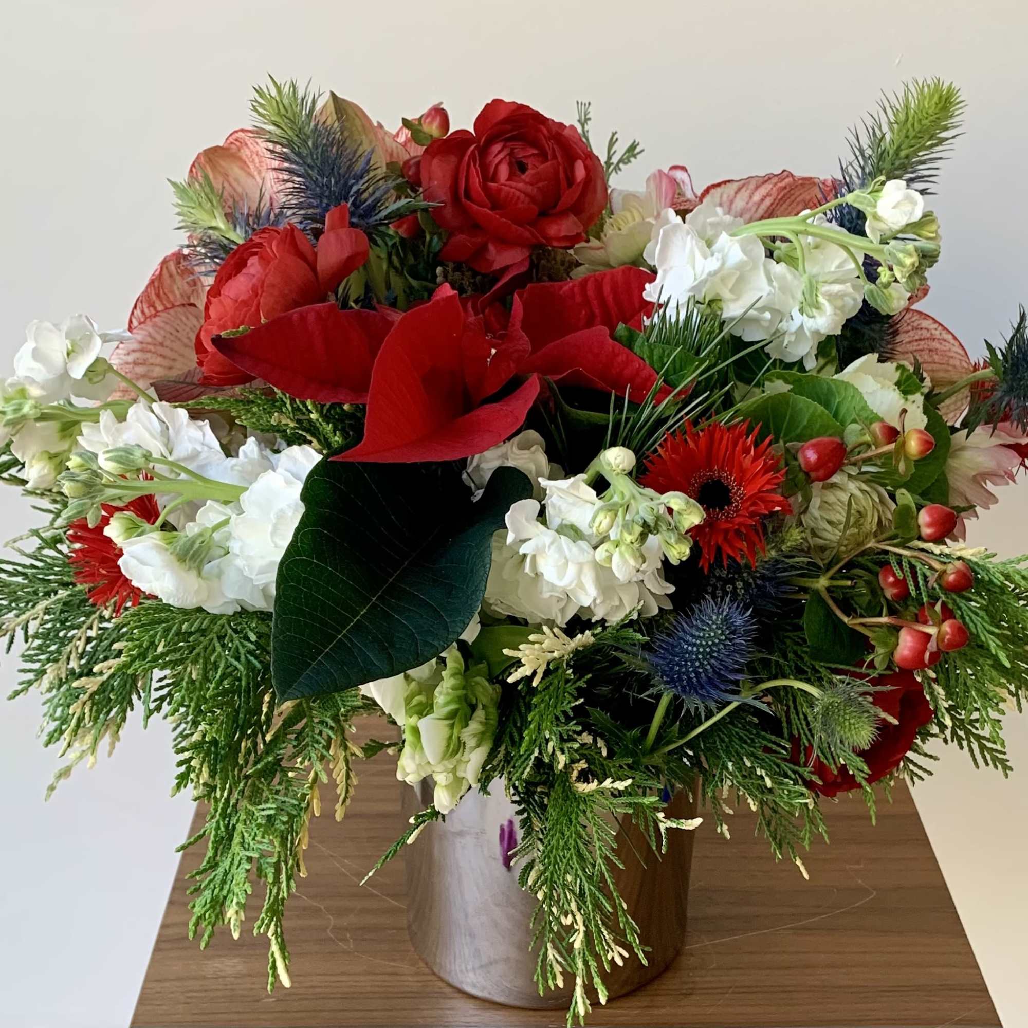 Lovely flower arrangement in a shiny cylinder vase with a variety of