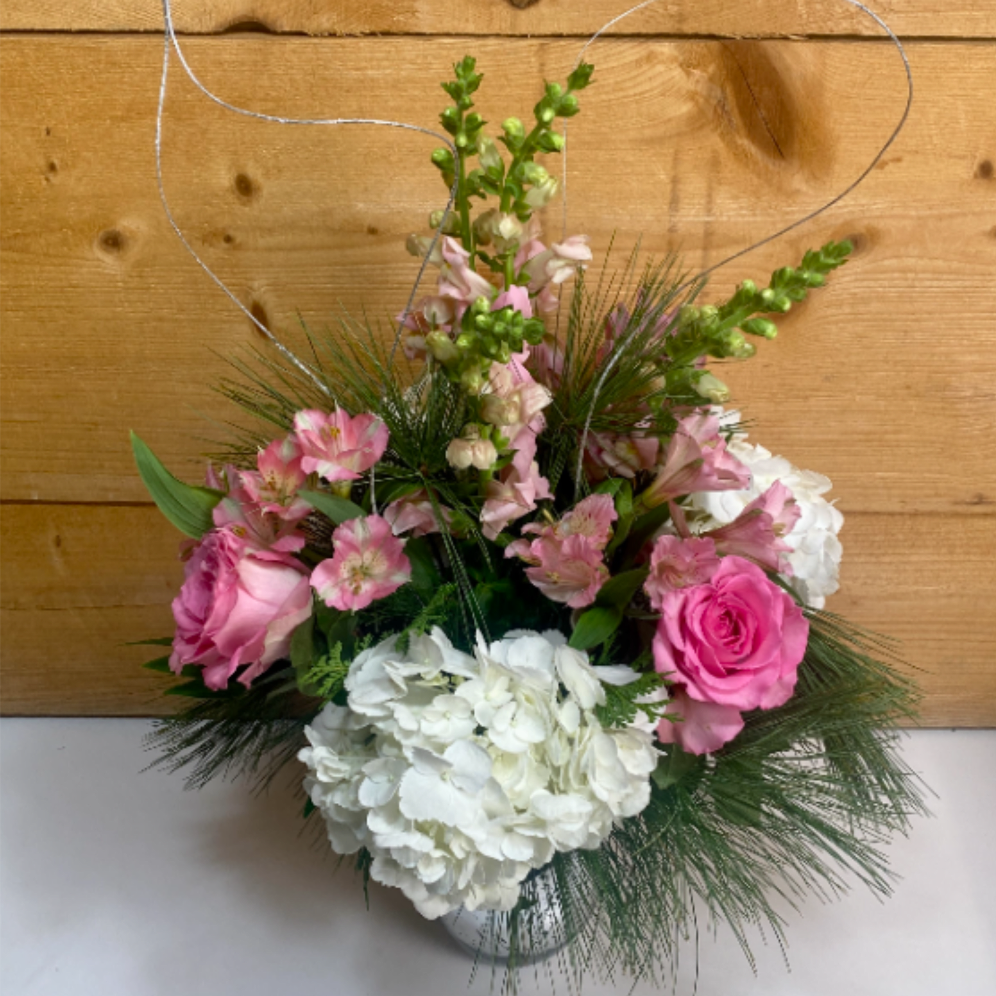 The Pretty in Pink Holiday Bouquet is a charming arrangement that combines