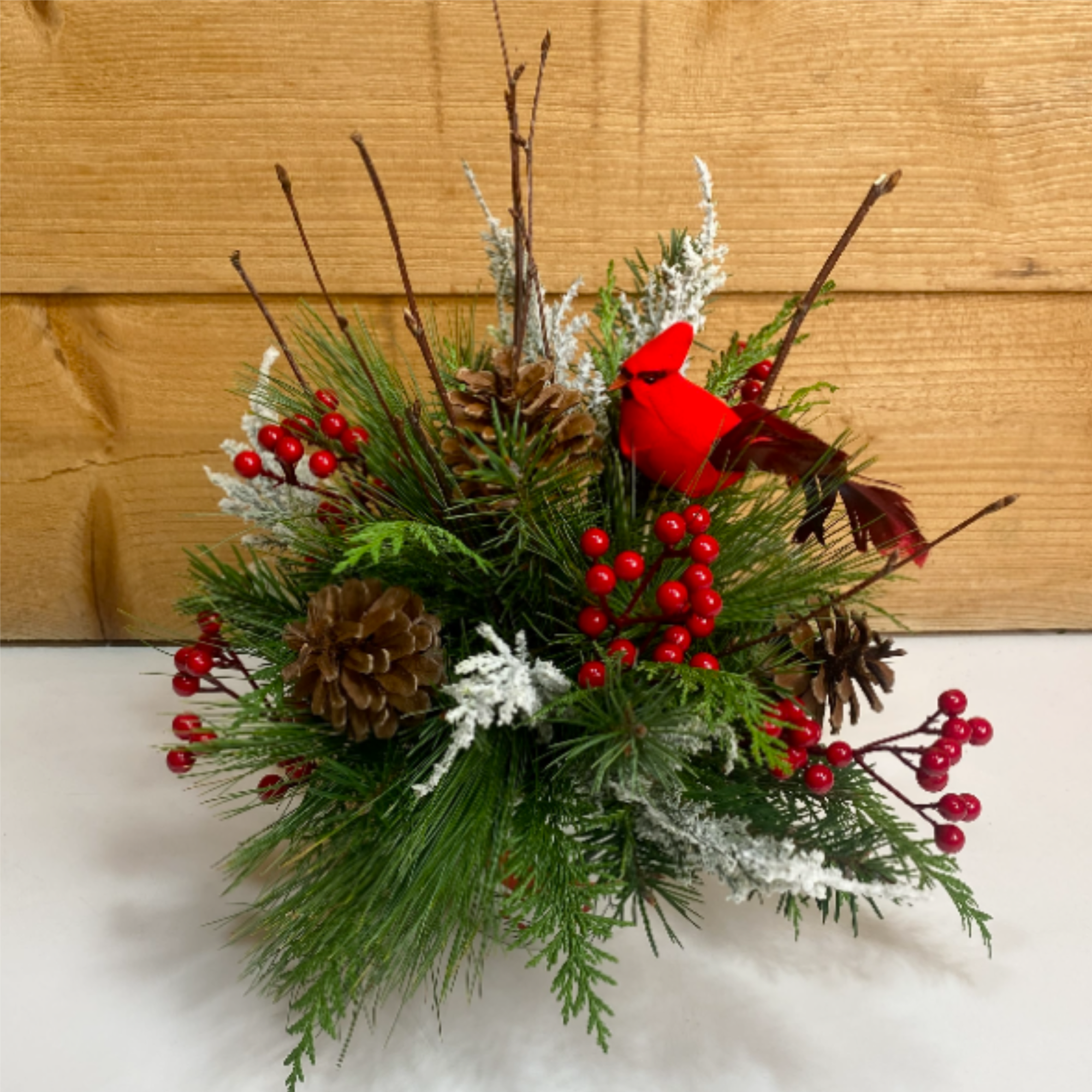 Cardinal Christmas is a delightful arrangement for the winter season, with a