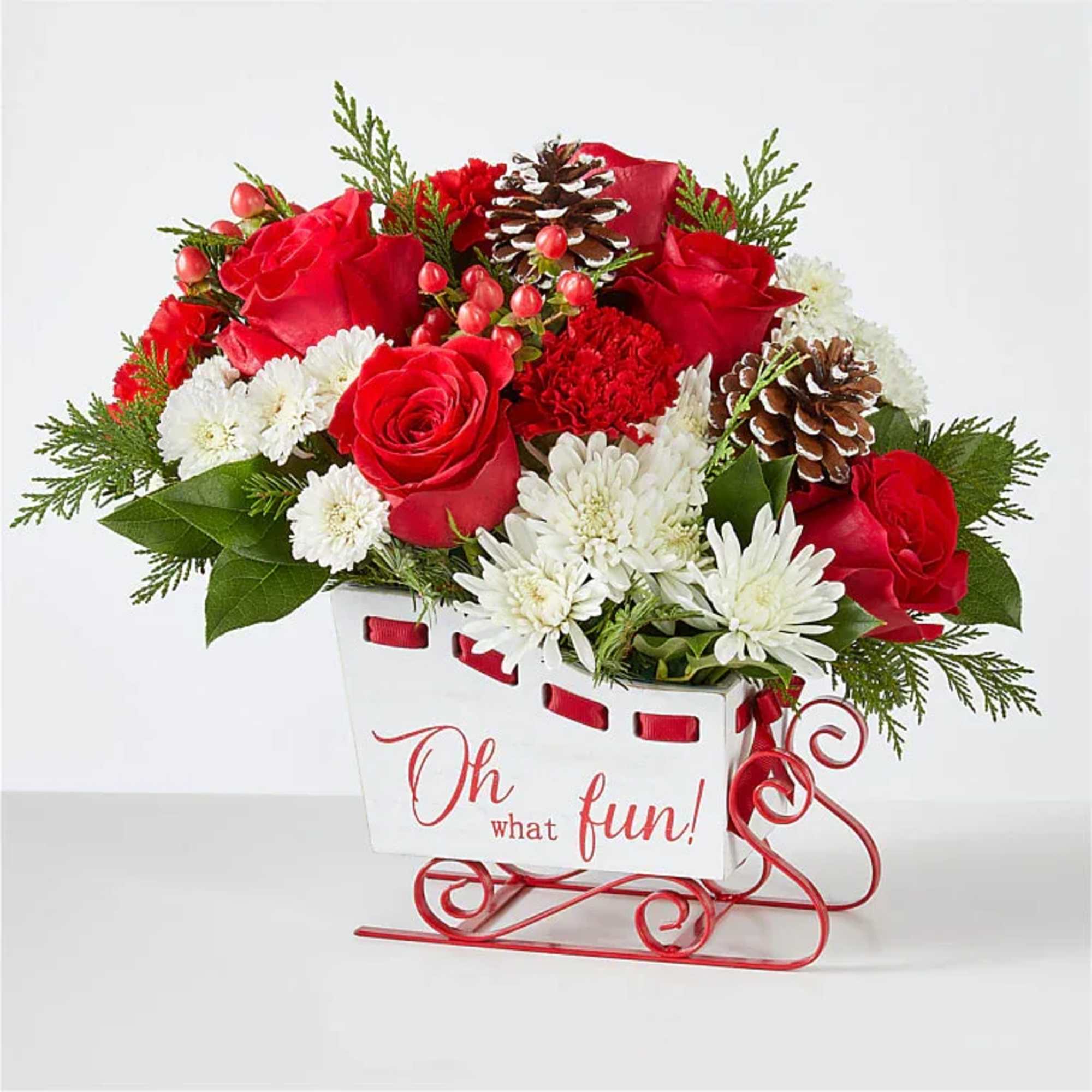 Sled into the holiday season with this lush arrangement of red roses