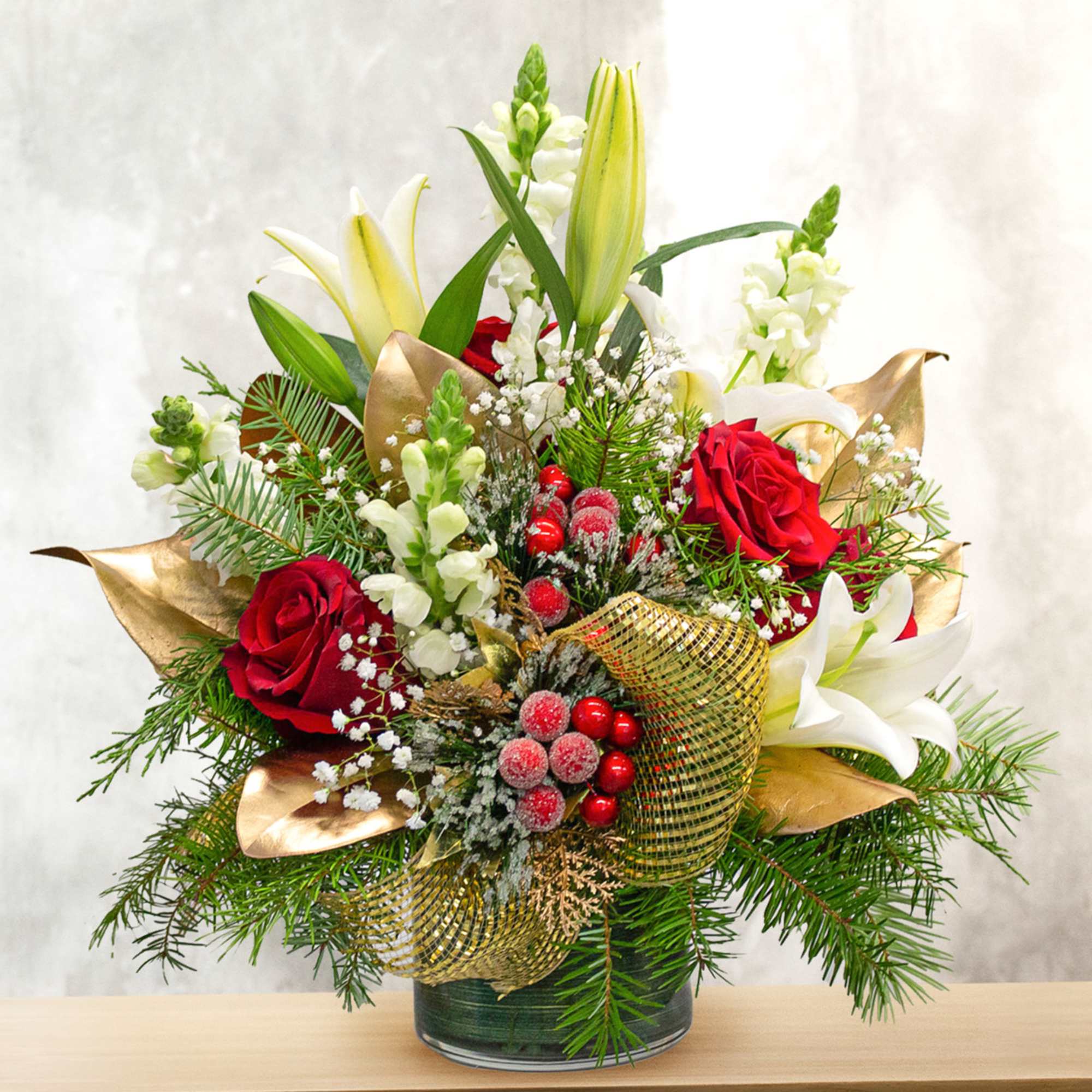 This unique holiday design includes lilies, roses, snapdragon, magnolia leaves and holiday